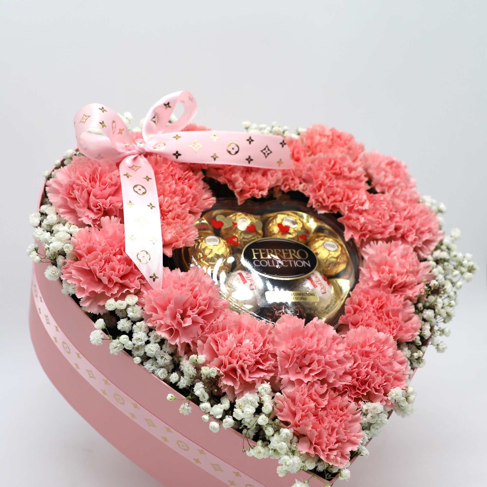 This box contains pink carnations and babys breath that is beautifully arranged