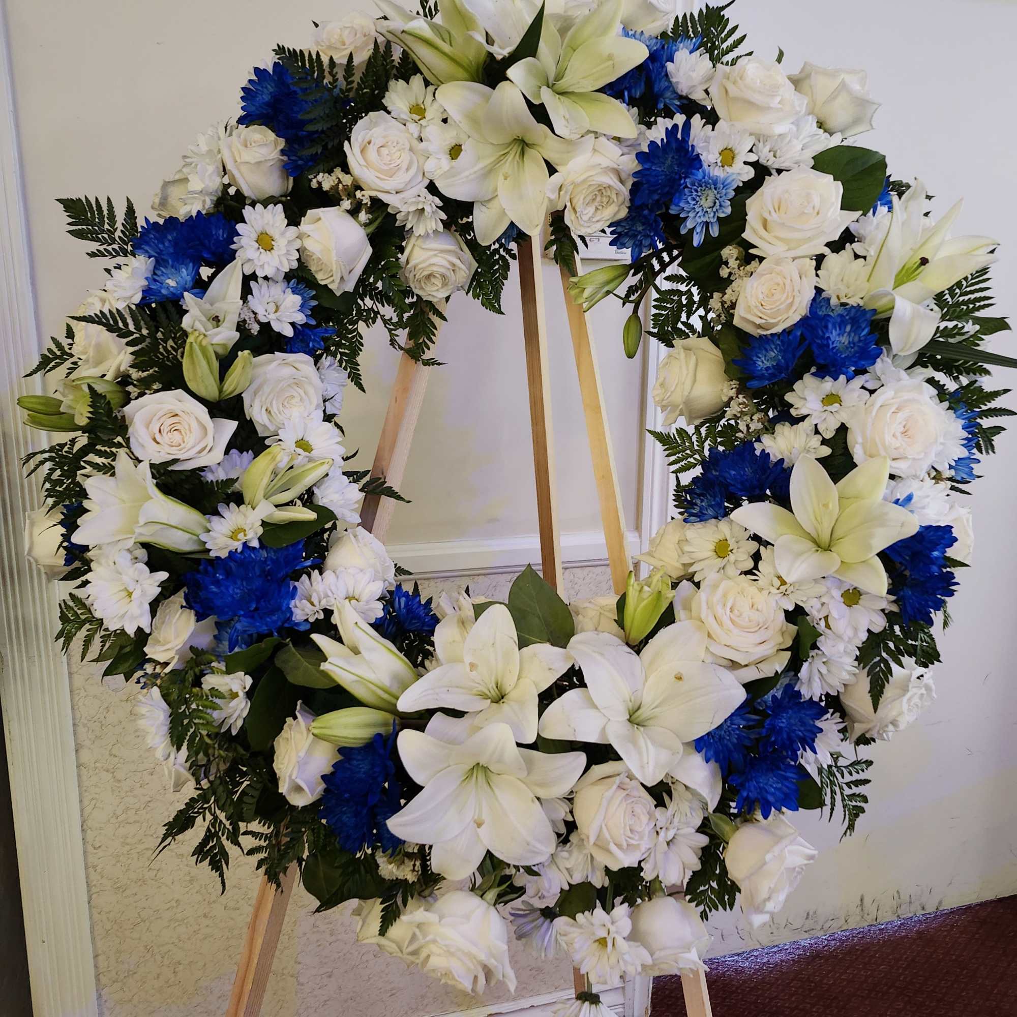Large blue and white sympathy wreath. Perfect for a male's services. It