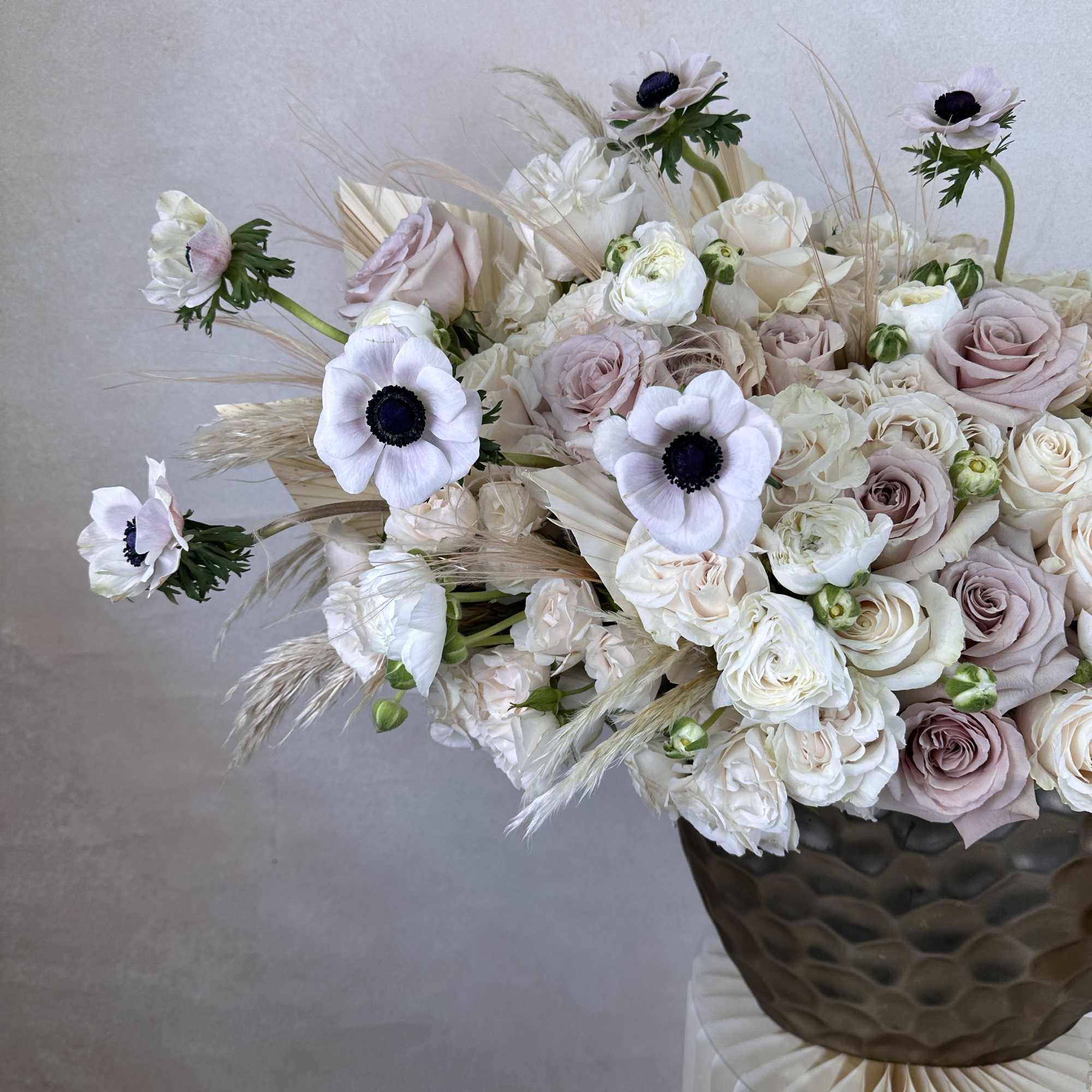 A stylish fusion of fresh, high-end flowers designed in a statement vase.