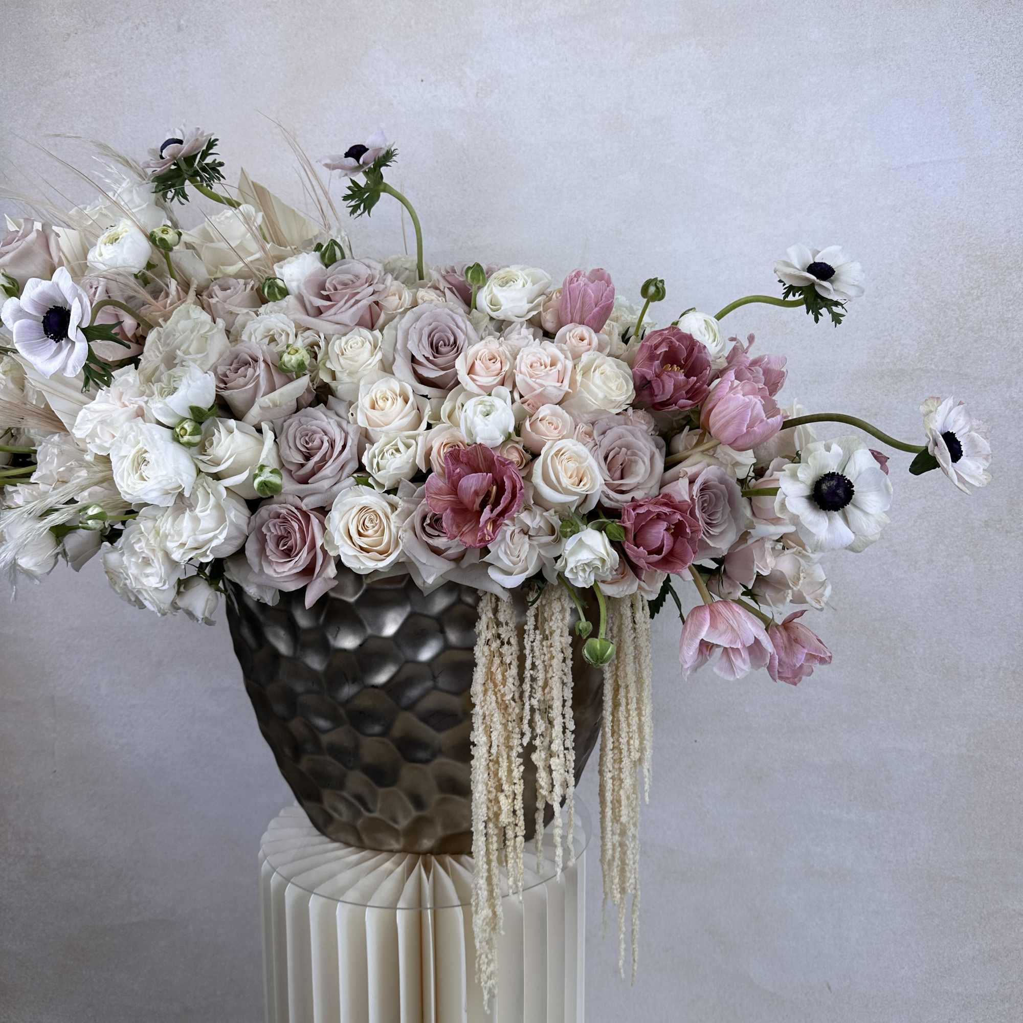 A stylish fusion of fresh, high-end flowers designed in a statement vase.