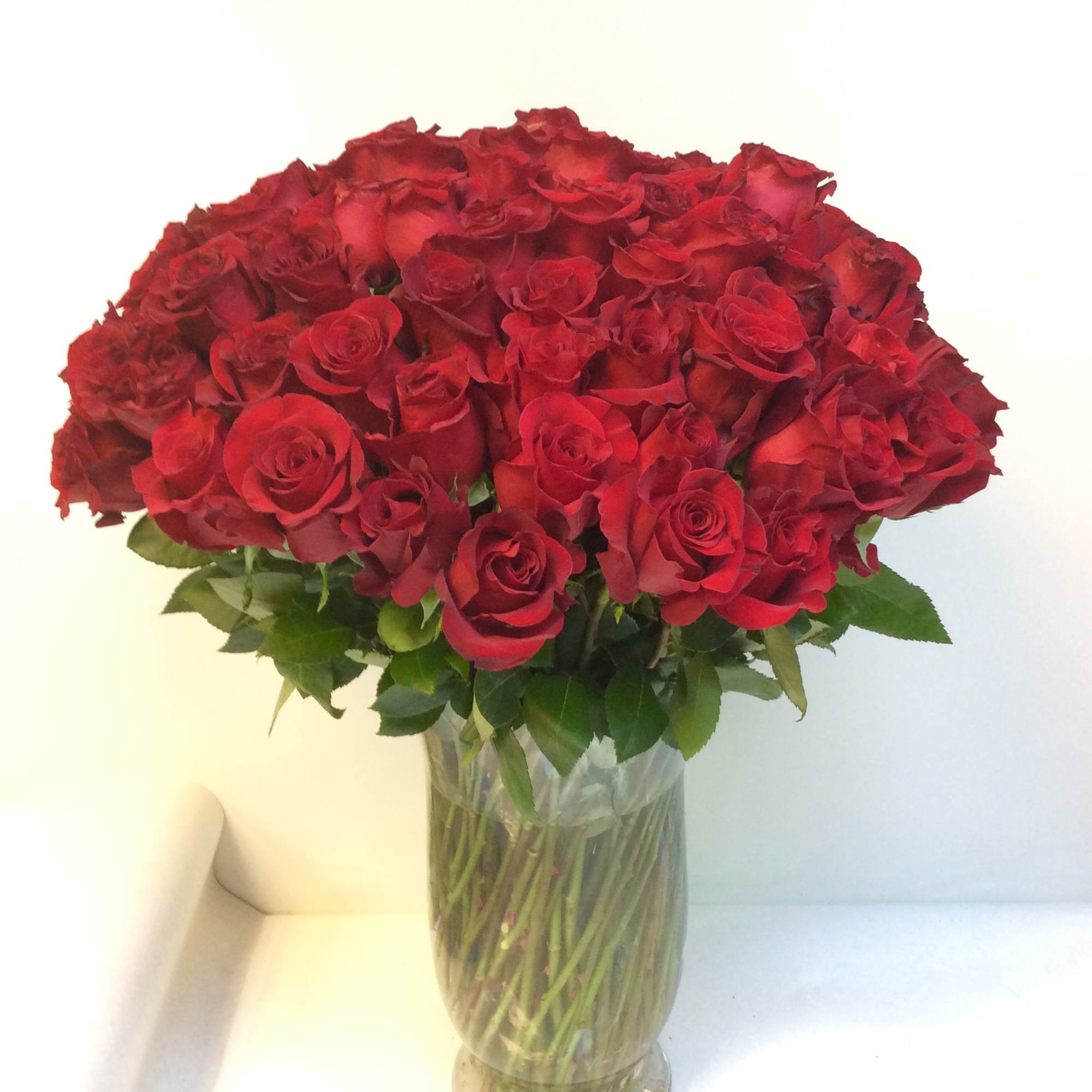 This 100 red rose arrangement is sure to make an everlasting impression!