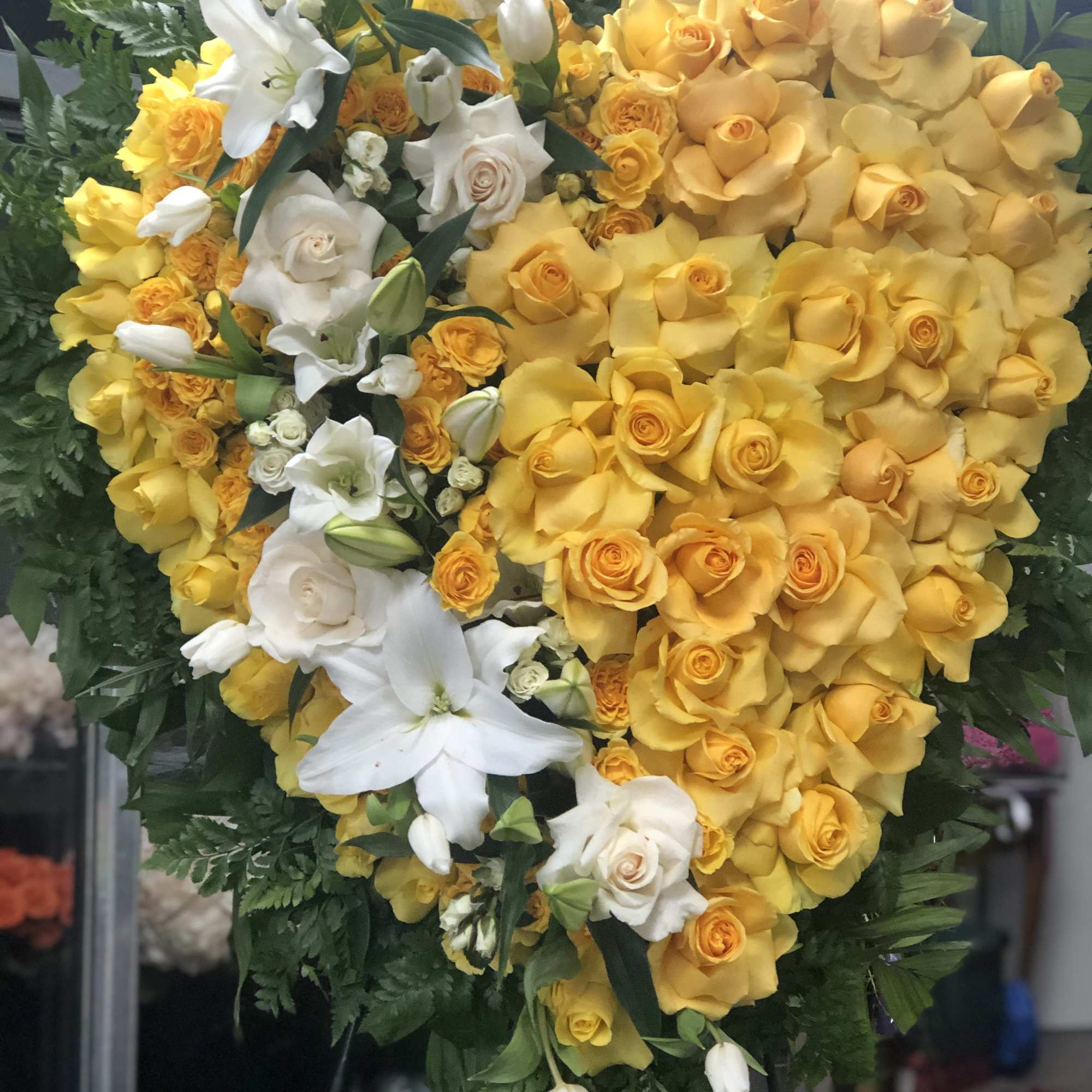 A full heart with open yellow roses and spray roses ,like broken A full heart with open yellow roses and spray roses ,like broken