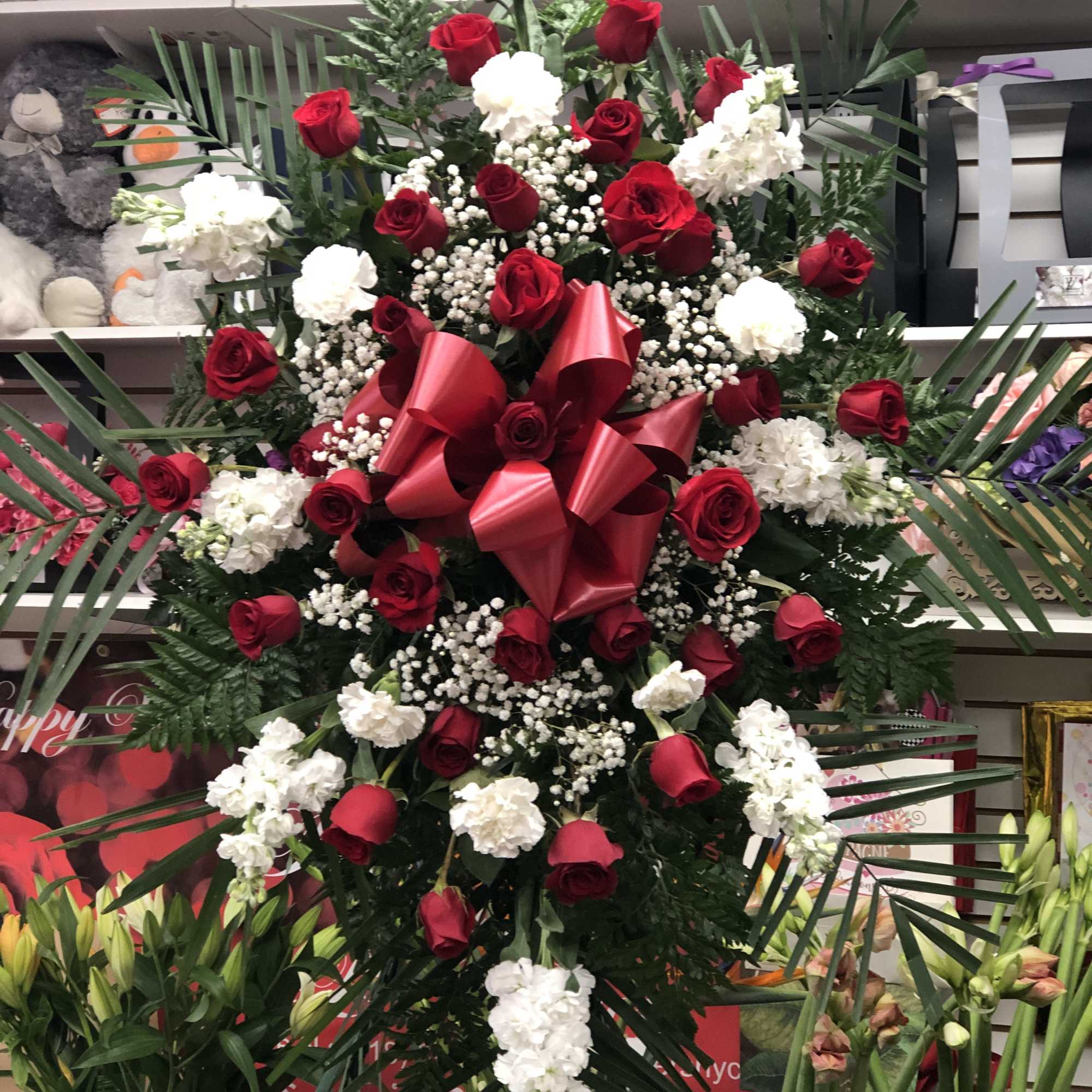 Standing spray with open red rose3s mixed with with stock ,elegant with Standing spray with open red rose3s mixed with with stock ,elegant with