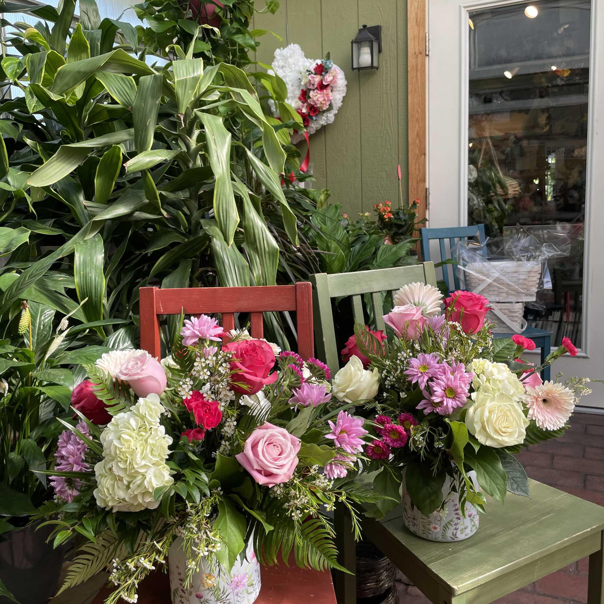Gorgeous pink or purple roses, blue delphiniums, green hydrangeas, lambs ear, and