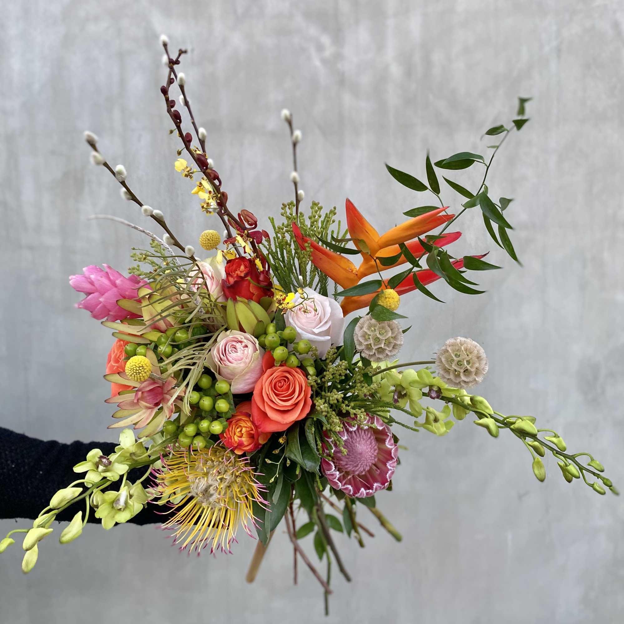  This wild bouquet includes a variety of seasonal blooms wrapped in