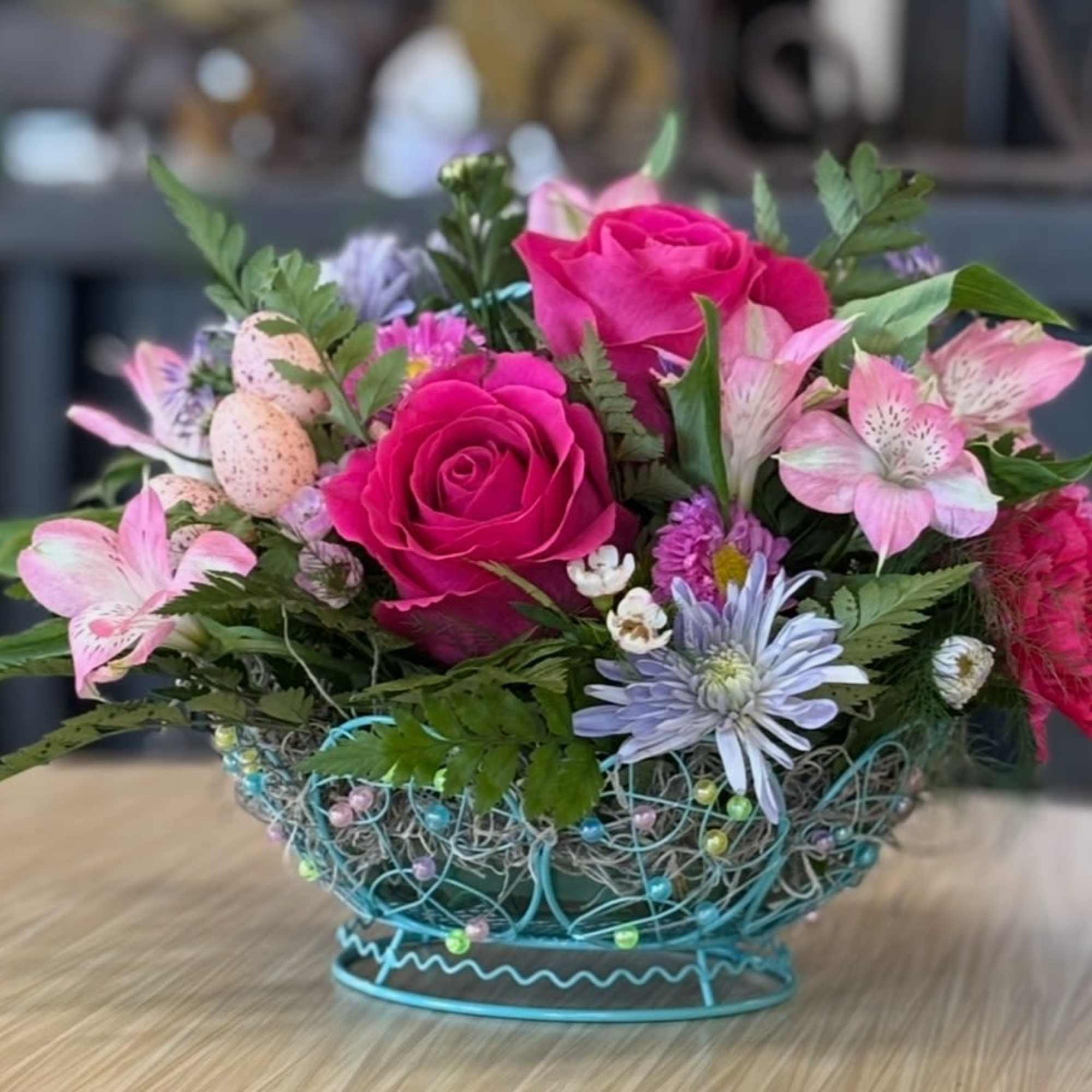 This basket of spring flowers features bright colors and Easter Greetings. 