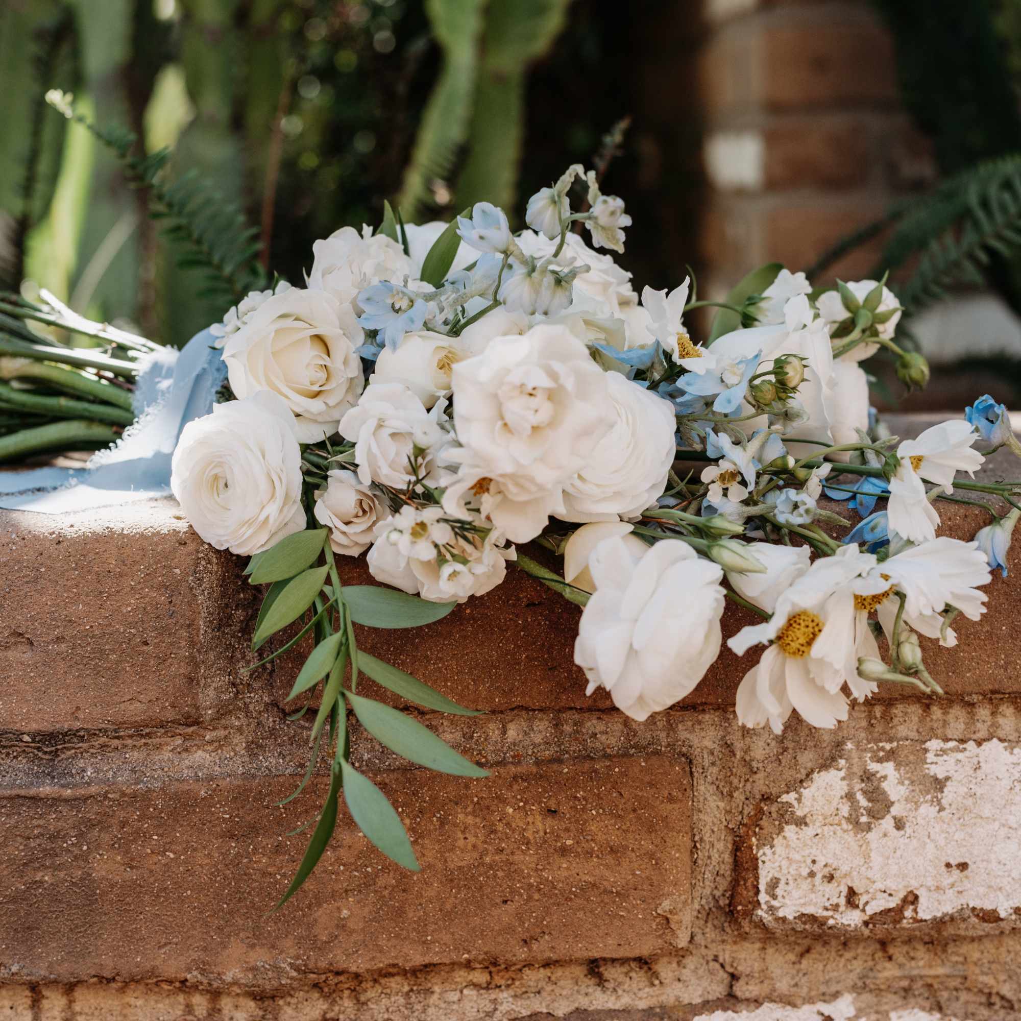 Signature Bridal bouquet bursting with beautiful blooms. Hand-tied and finished with romantic