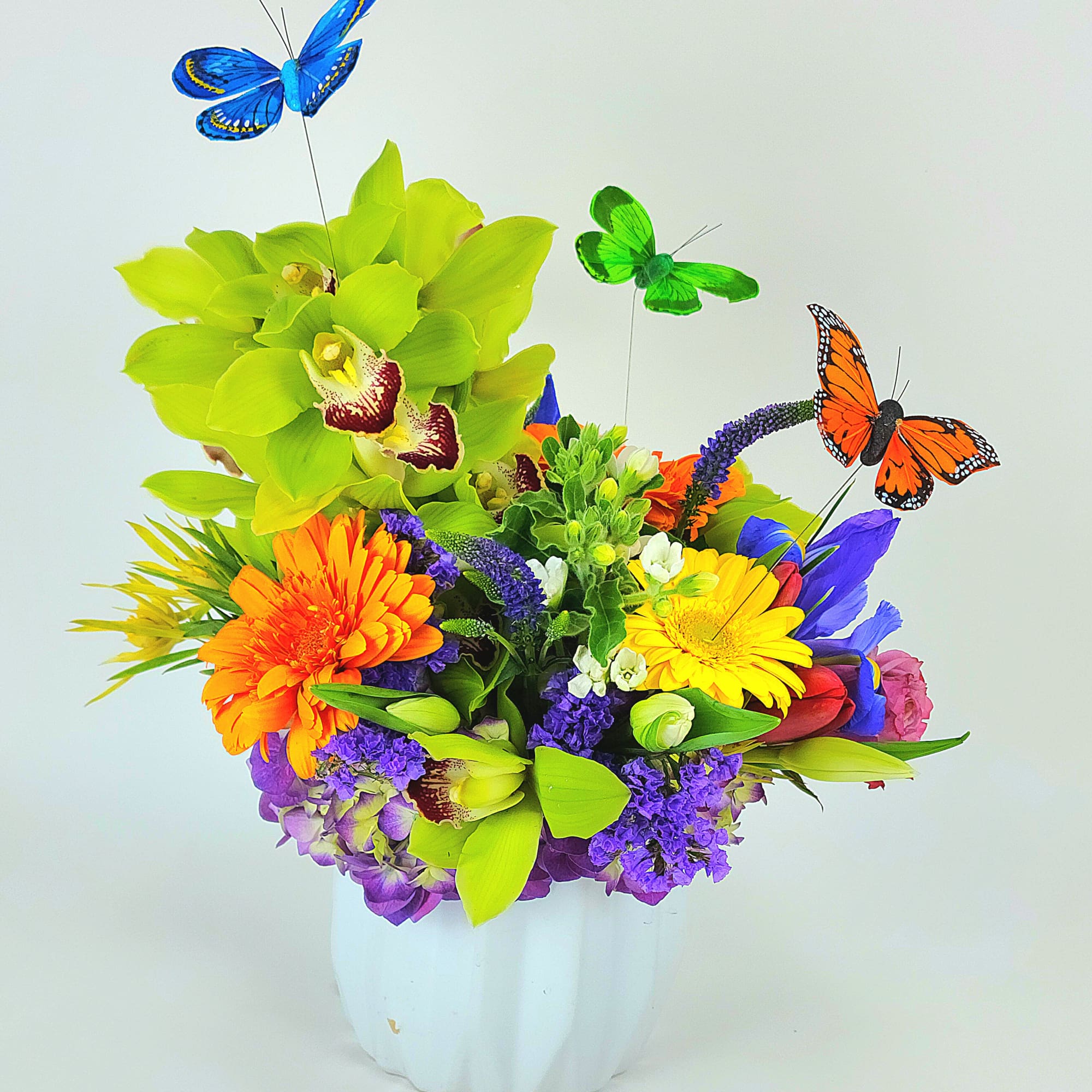 Beautiful spring colors arrangement with orchids, hydrangea, roses, and mix flowers