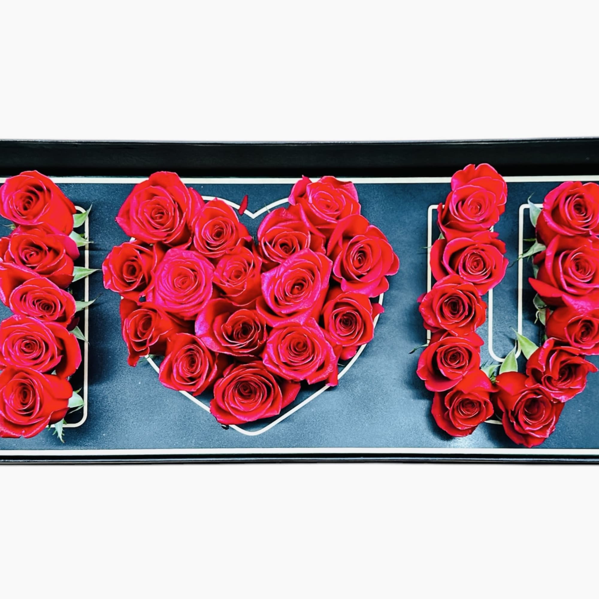 A beautifully arranged floral design using fresh red roses, forming the letters
