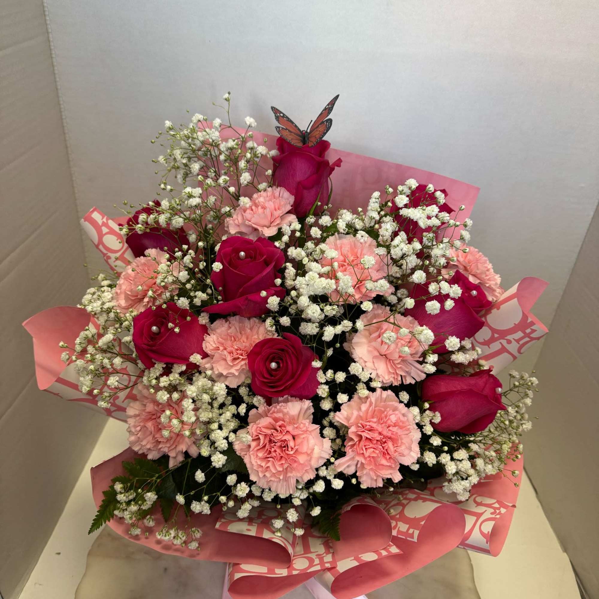 hot pink roses, pink carnations, baby&#039;s breath all in a piece of