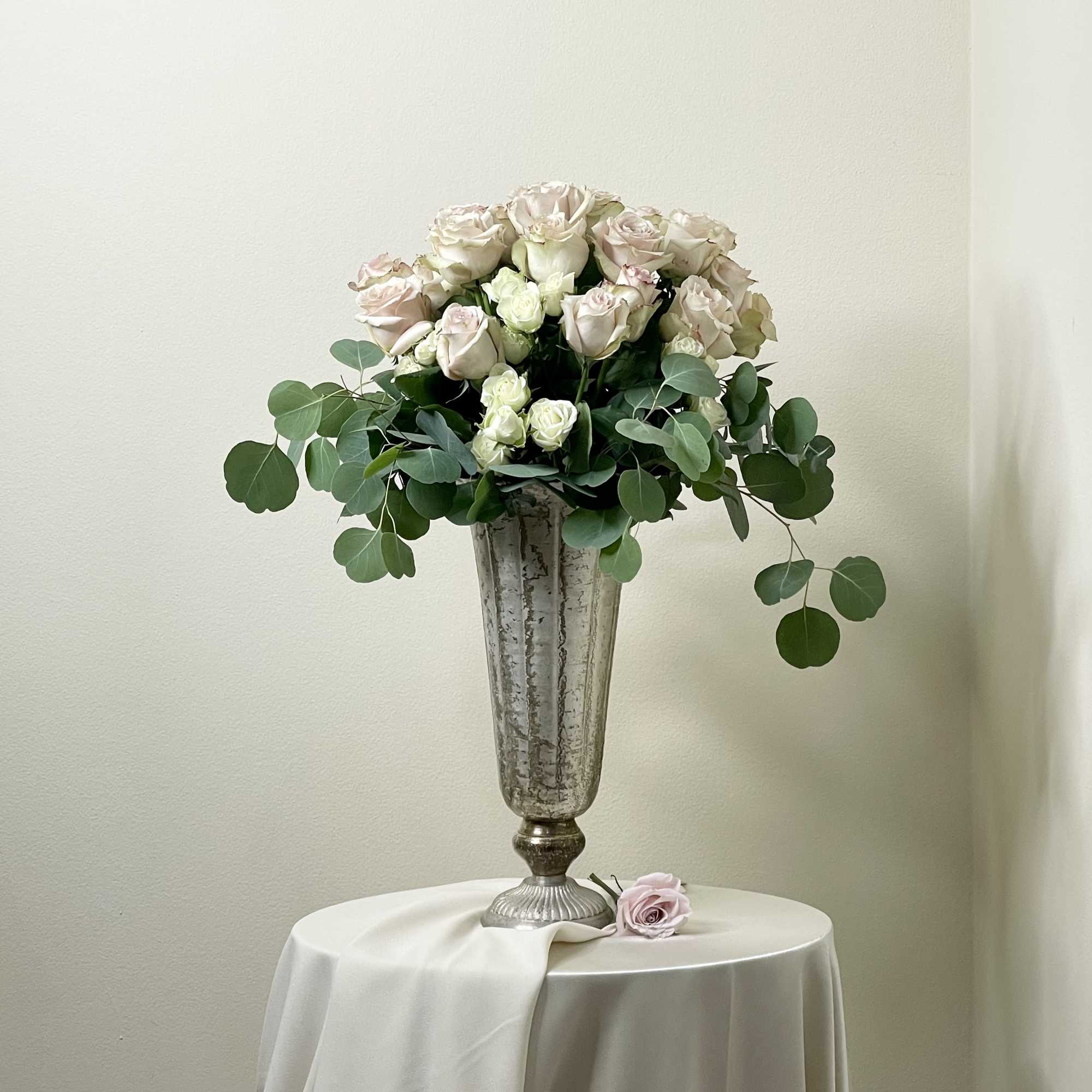 Roses at towering heights, this rose centric arrangement measure at approximately 28