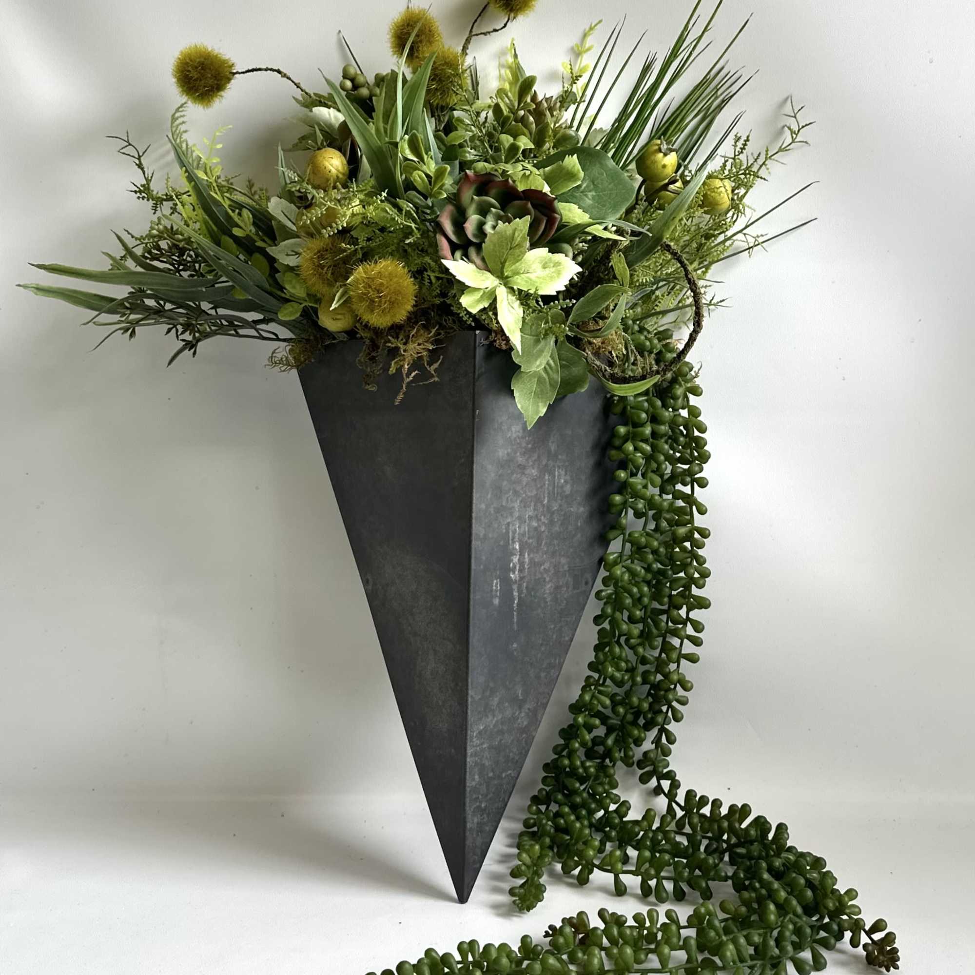Black Metal 14” Container filled with a variety of faux foliage and Black Metal 14” Container filled with a variety of faux foliage and