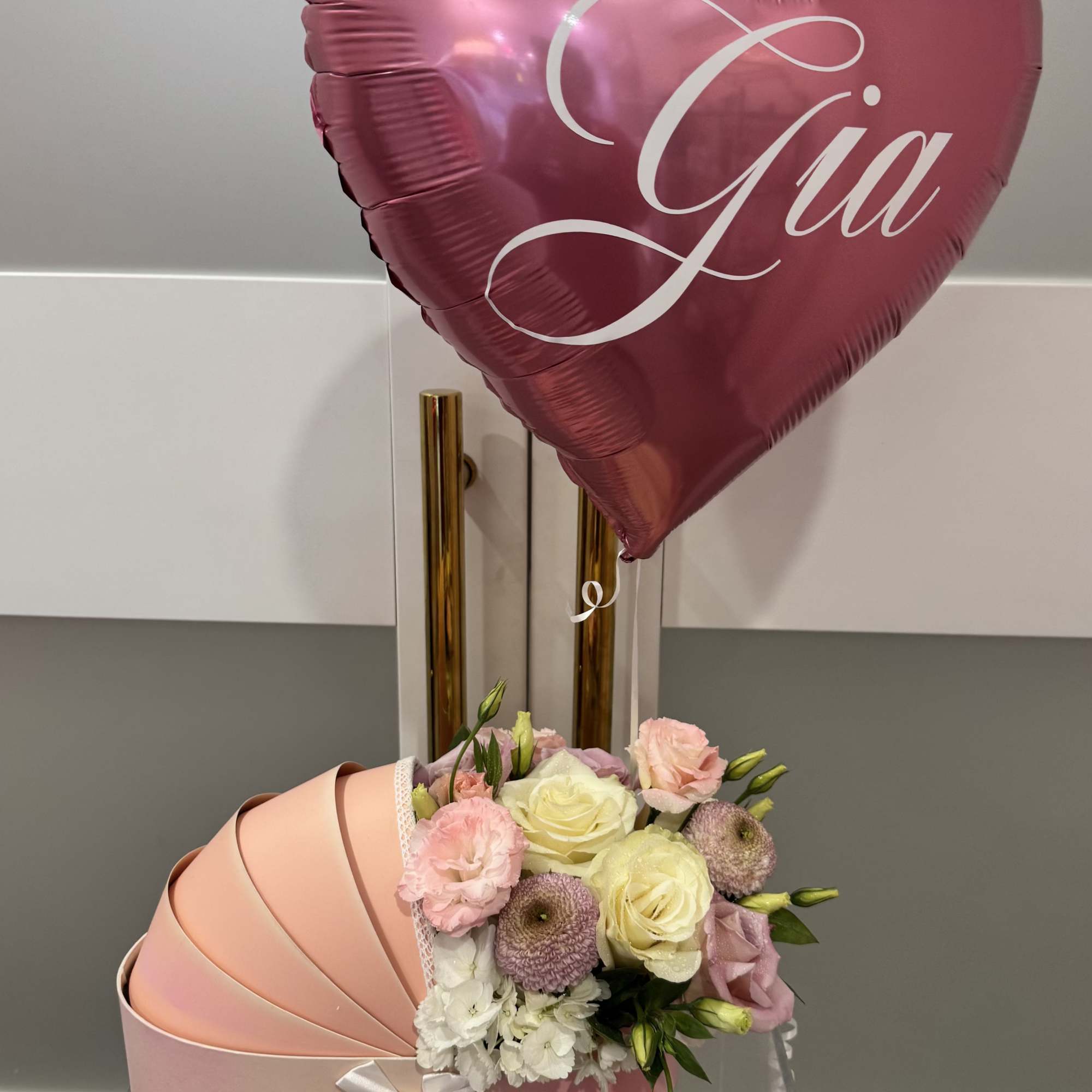 Premium floral designed in our signature carriage box with a personalized balloon