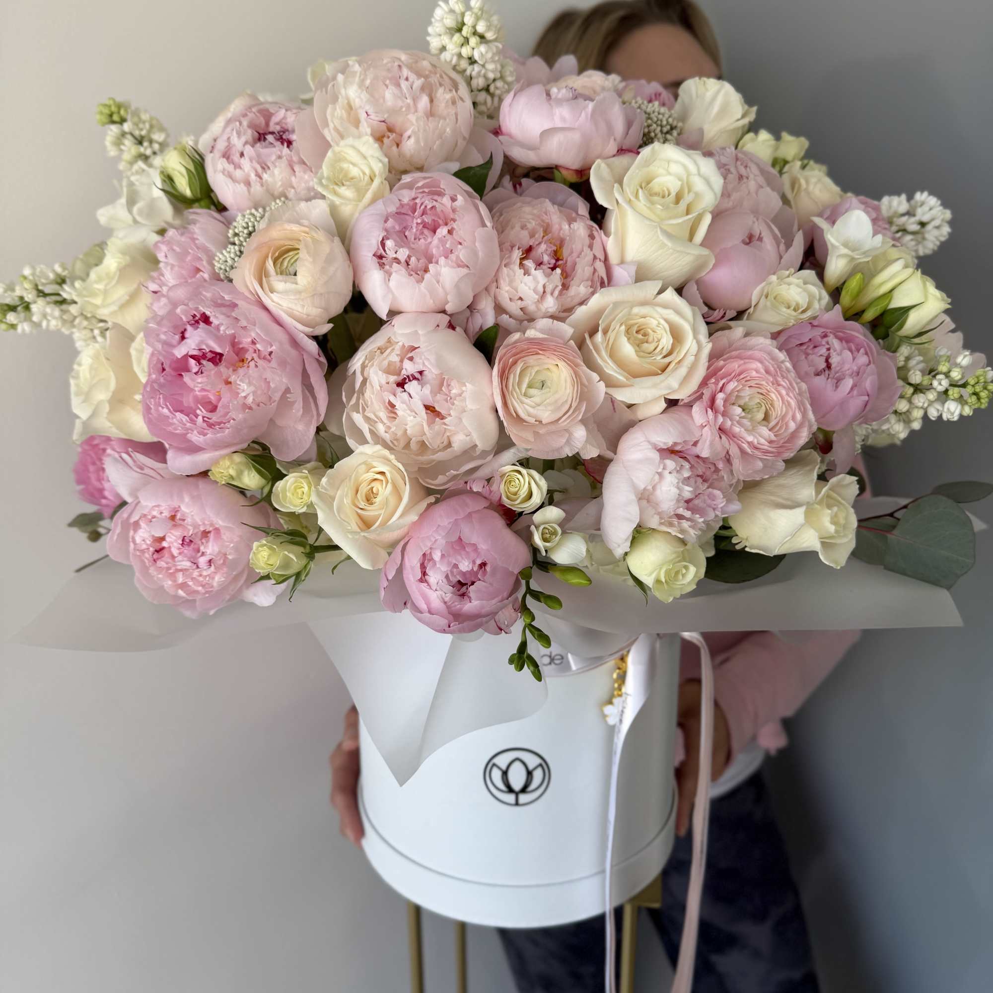 A breathtakingly romantic arrangement of delicate pink peonies, creamy white roses, and A breathtakingly romantic arrangement of delicate pink peonies, creamy white roses, and
