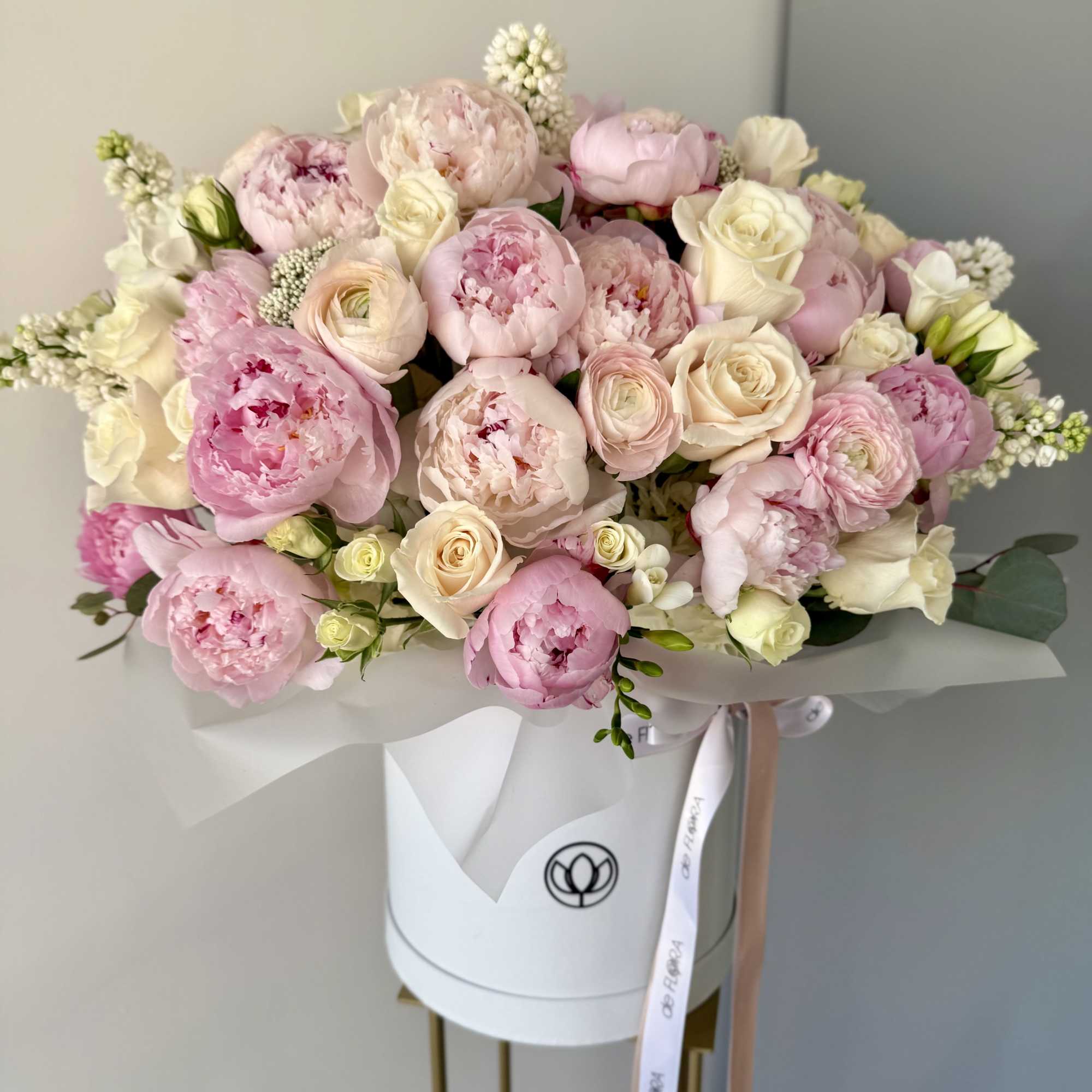 A breathtakingly romantic arrangement of delicate pink peonies, creamy white roses, and A breathtakingly romantic arrangement of delicate pink peonies, creamy white roses, and