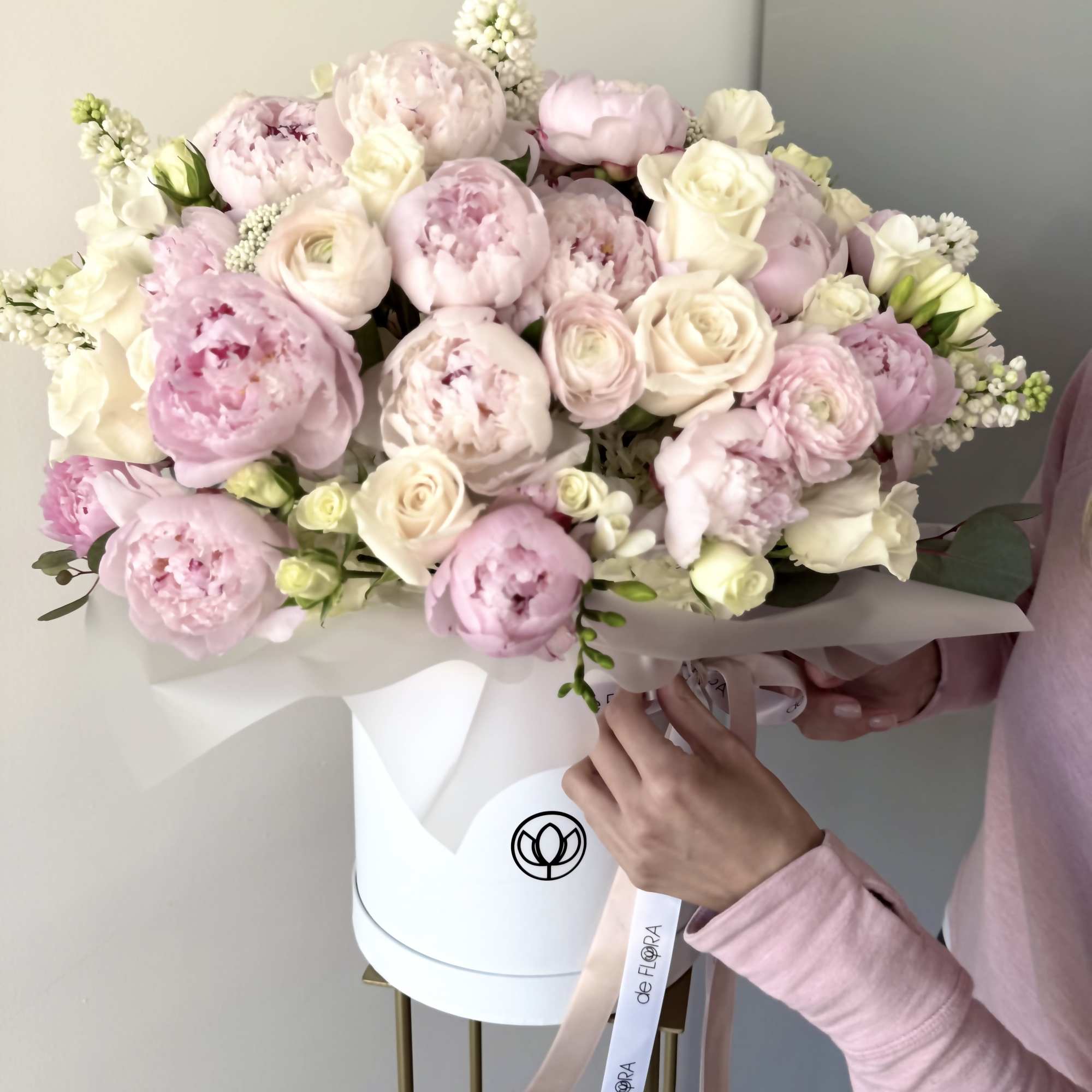 A breathtakingly romantic arrangement of delicate pink peonies, creamy white roses, and A breathtakingly romantic arrangement of delicate pink peonies, creamy white roses, and