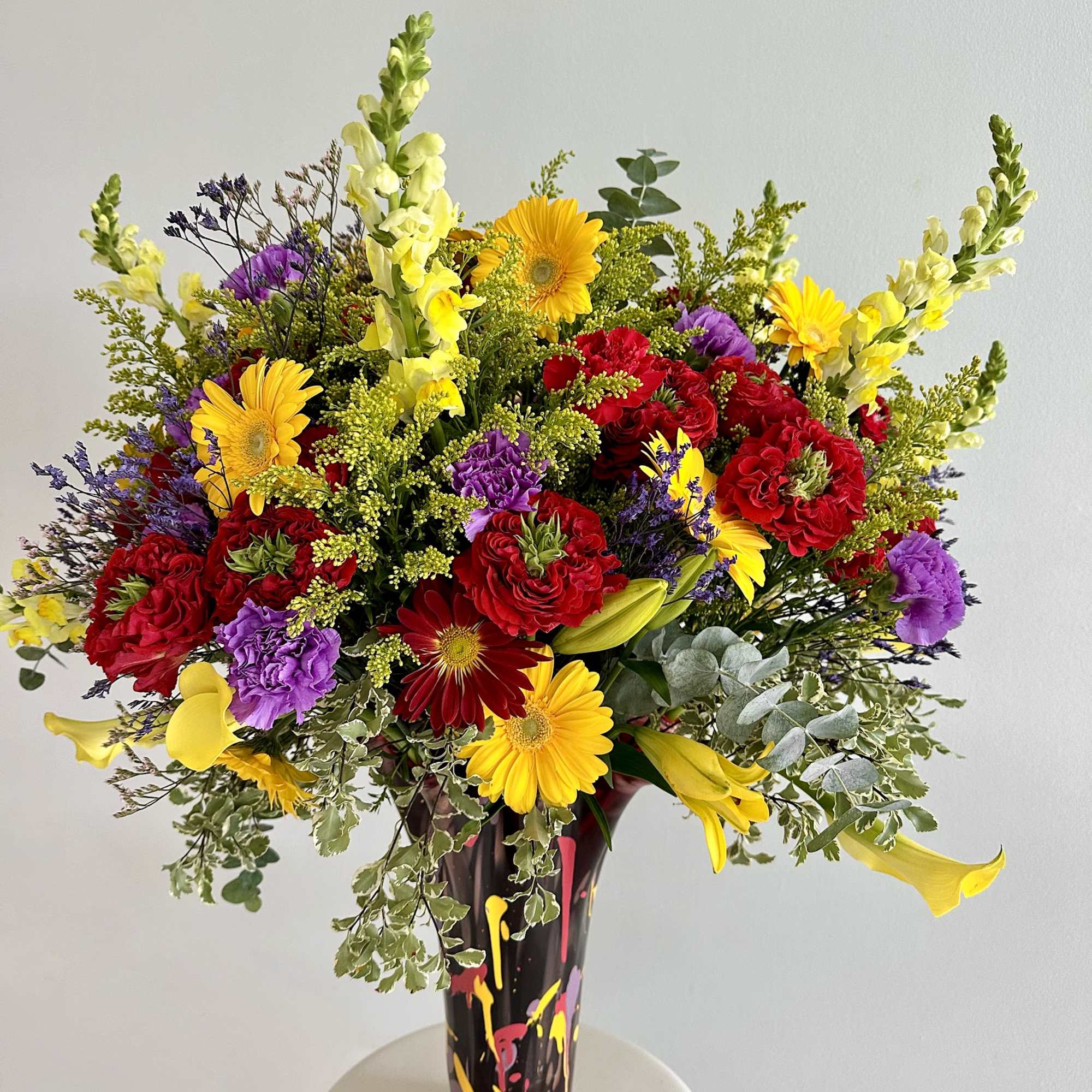 The &quot;Vibrant Garden Vase&quot; is a lively and colorful arrangement that bursts