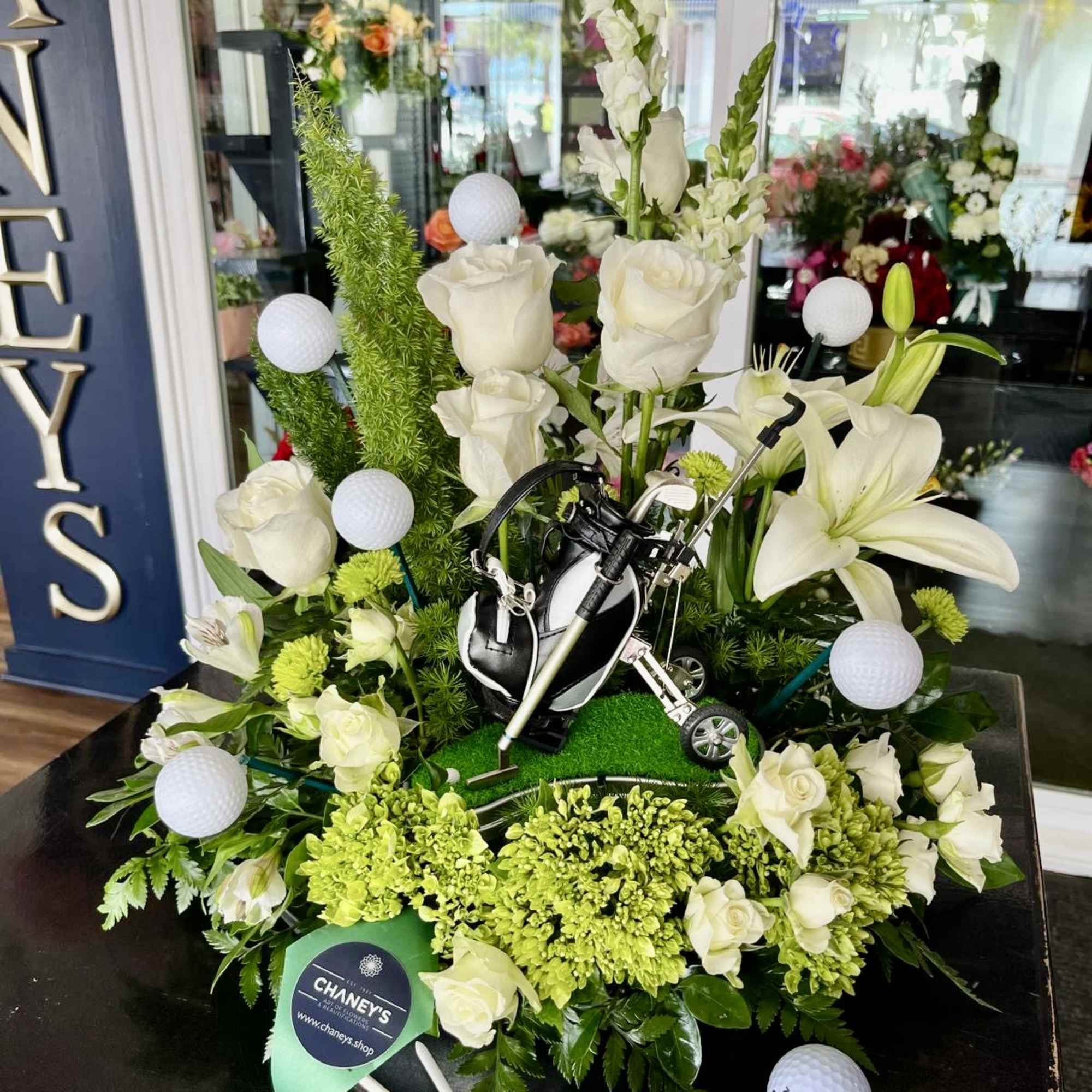 A stunning floral Golf combination with Premium Flowers, Golfballs and a Golf