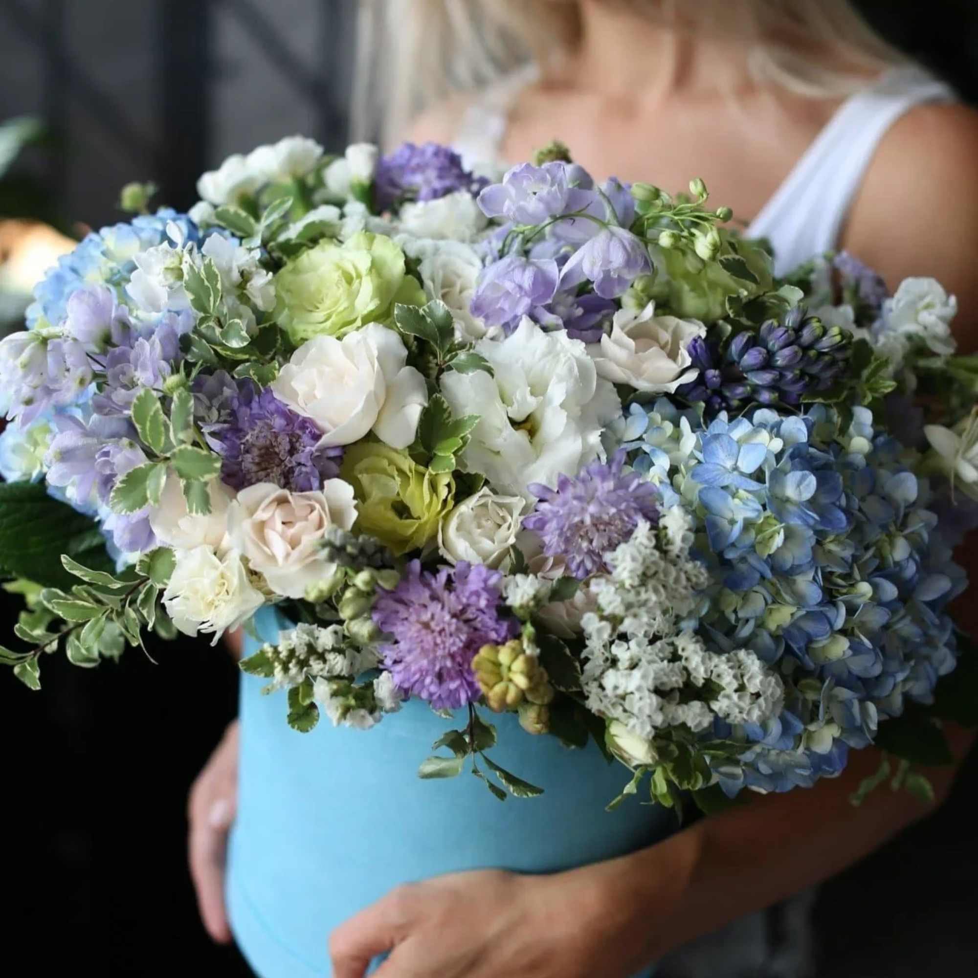 Lia is a stunning arrangement that includes hydrangeas, lisianthus, carnations, roses and