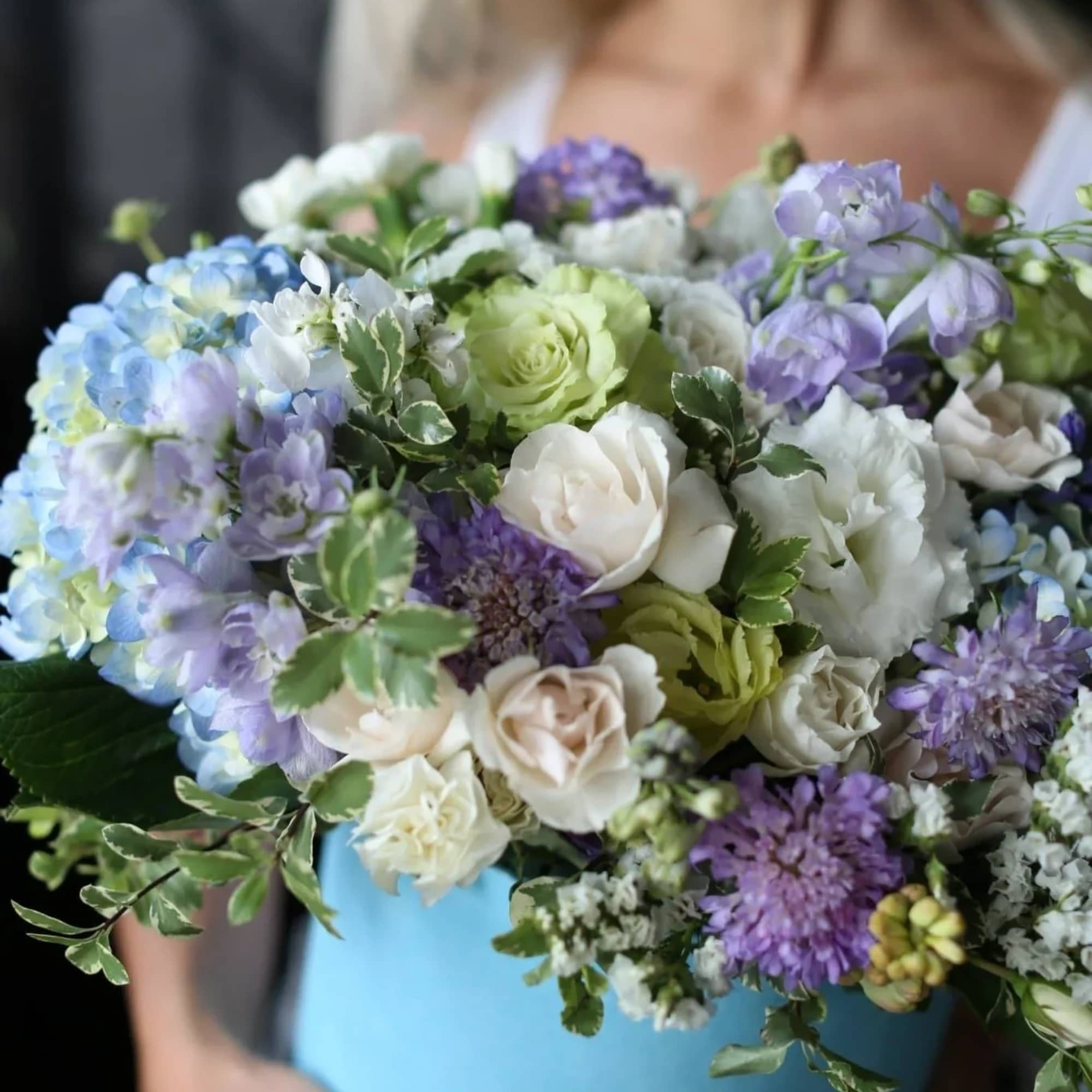 Lia is a stunning arrangement that includes hydrangeas, lisianthus, carnations, roses and
