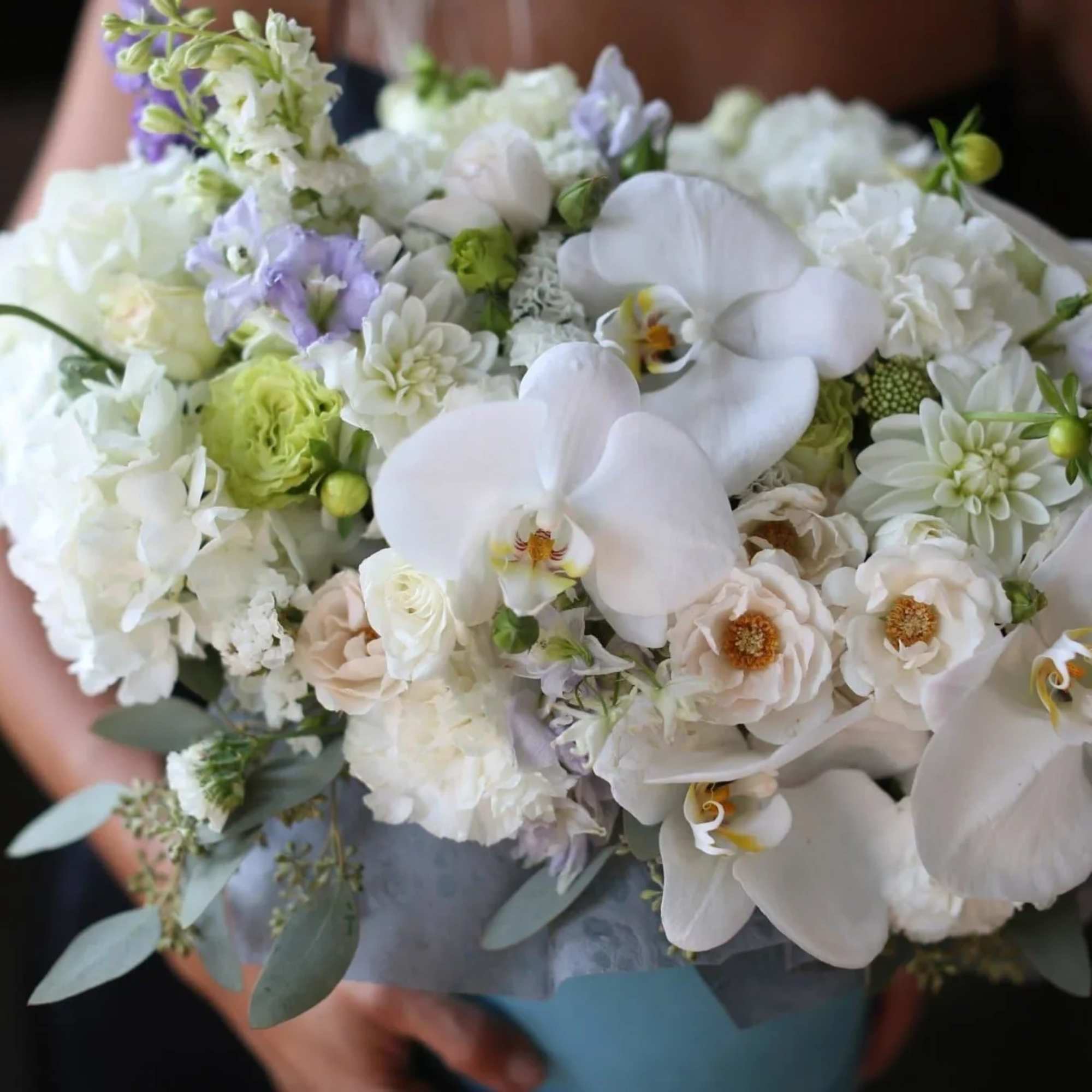 Dale is a composition with orchids, chrysanthemums (mums), hydrangeas and roses in