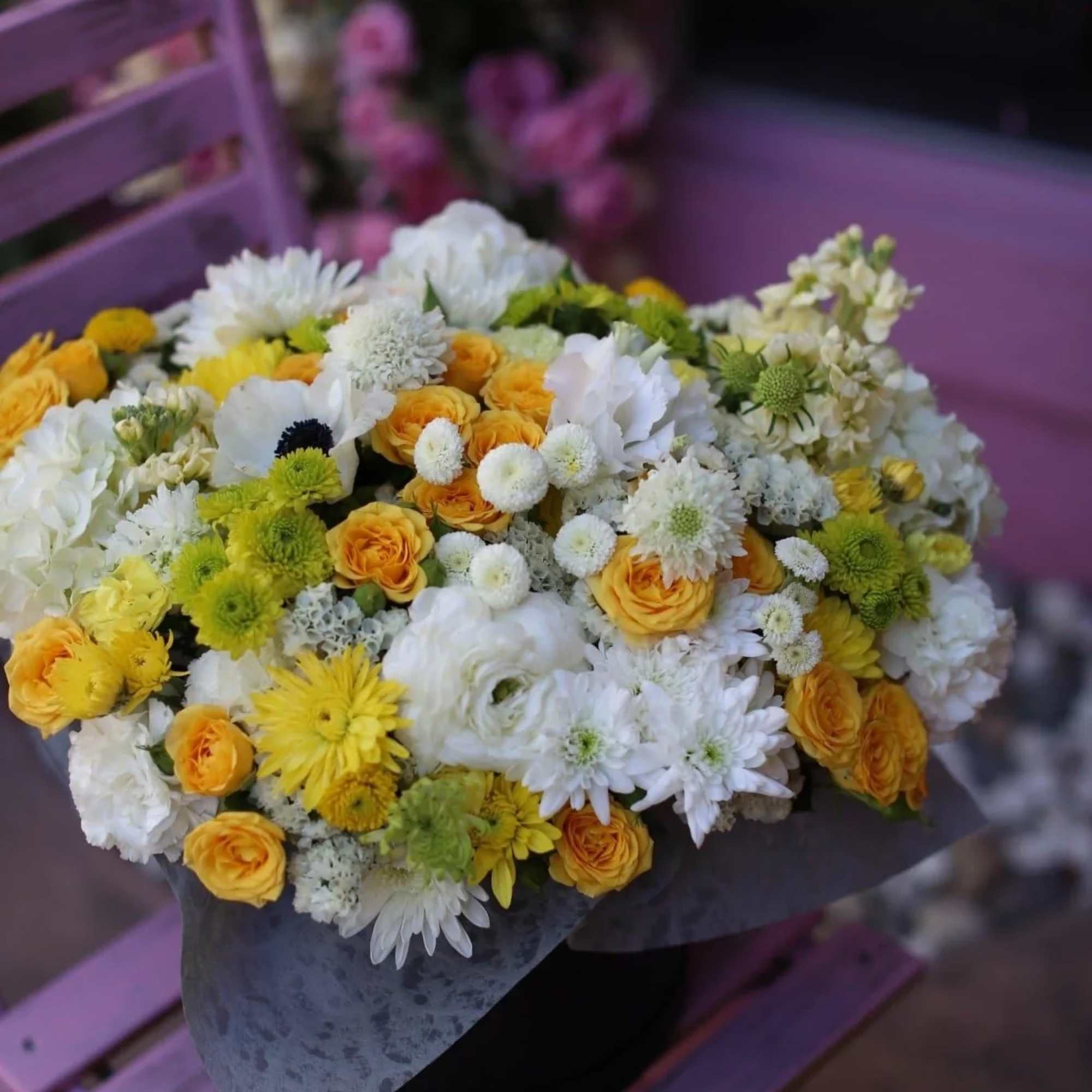 Evangeline is a stunning arrangement with anemones, ranunculus, roses and delphiniums in