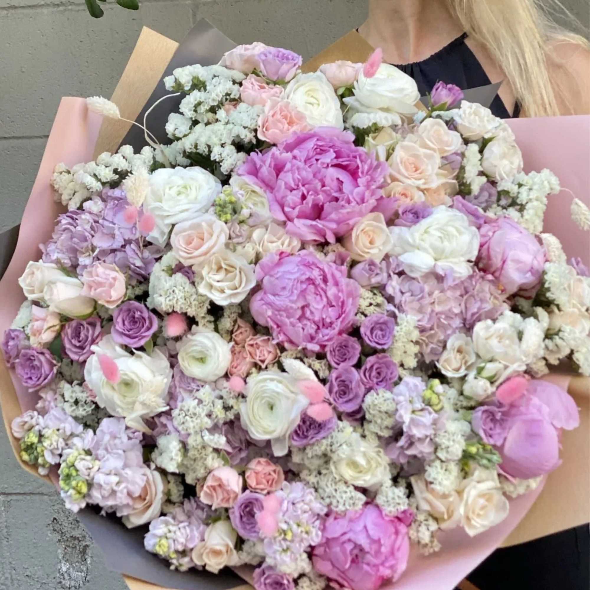 Milana is a stunning bouquet with peonies, garden roses with some greenery