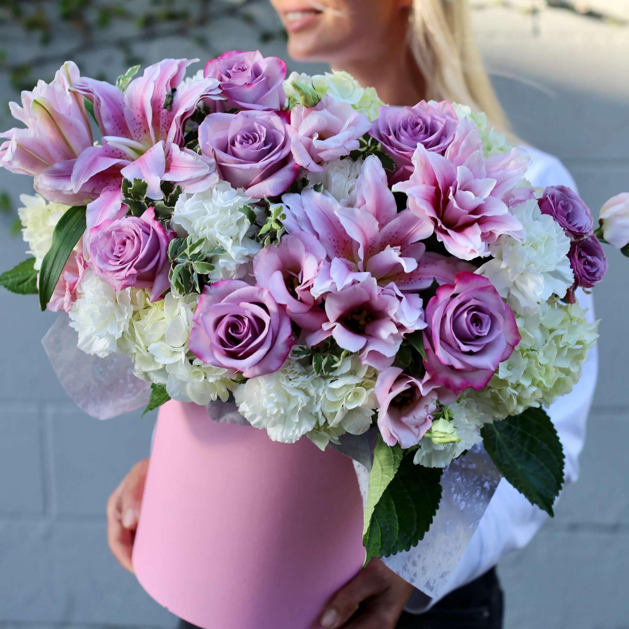Amazing pink flower arrangement featuring white or pink lilies, white hydrangeas, pink