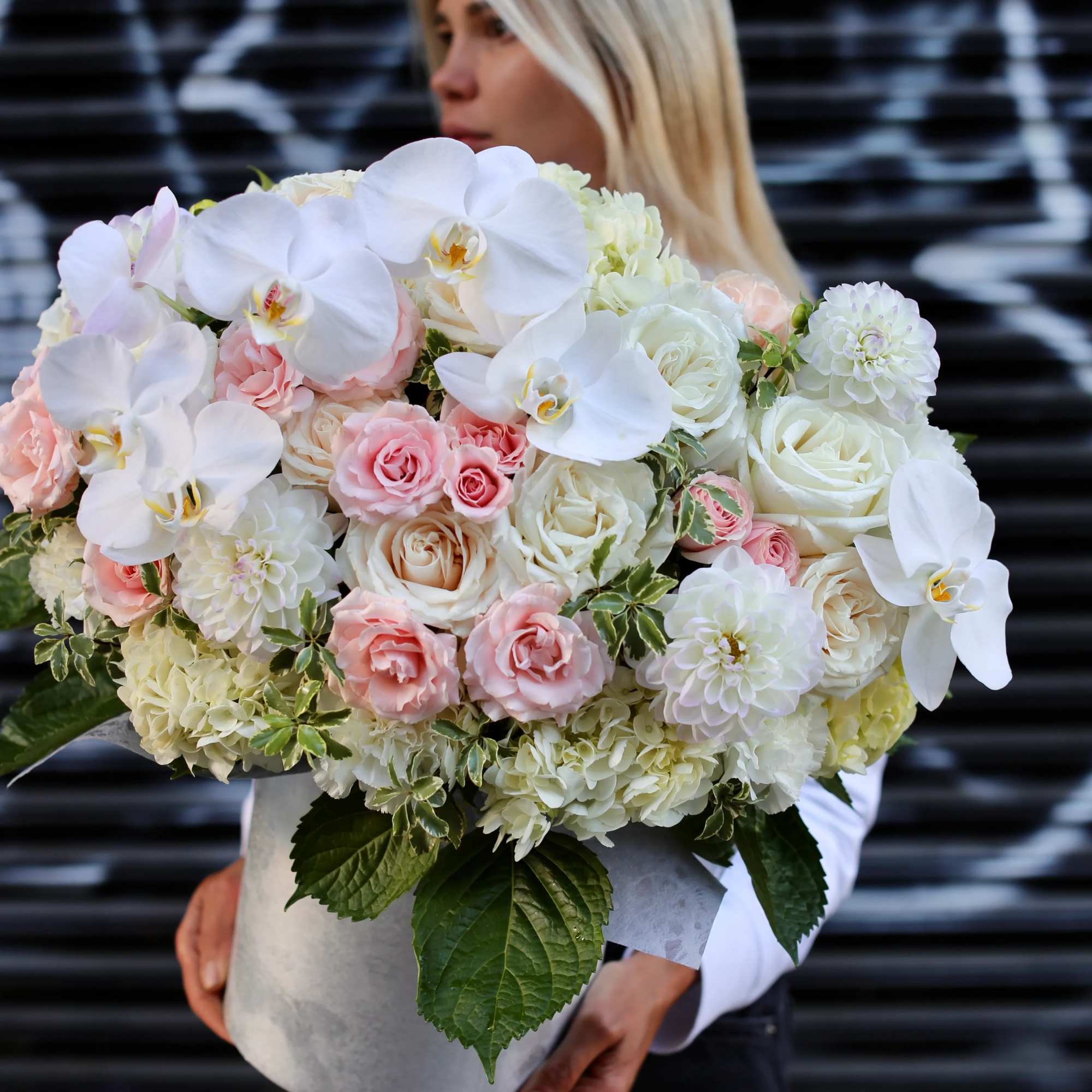 Lana is a huge floral arrangement of orchids, garden roses and dahlias