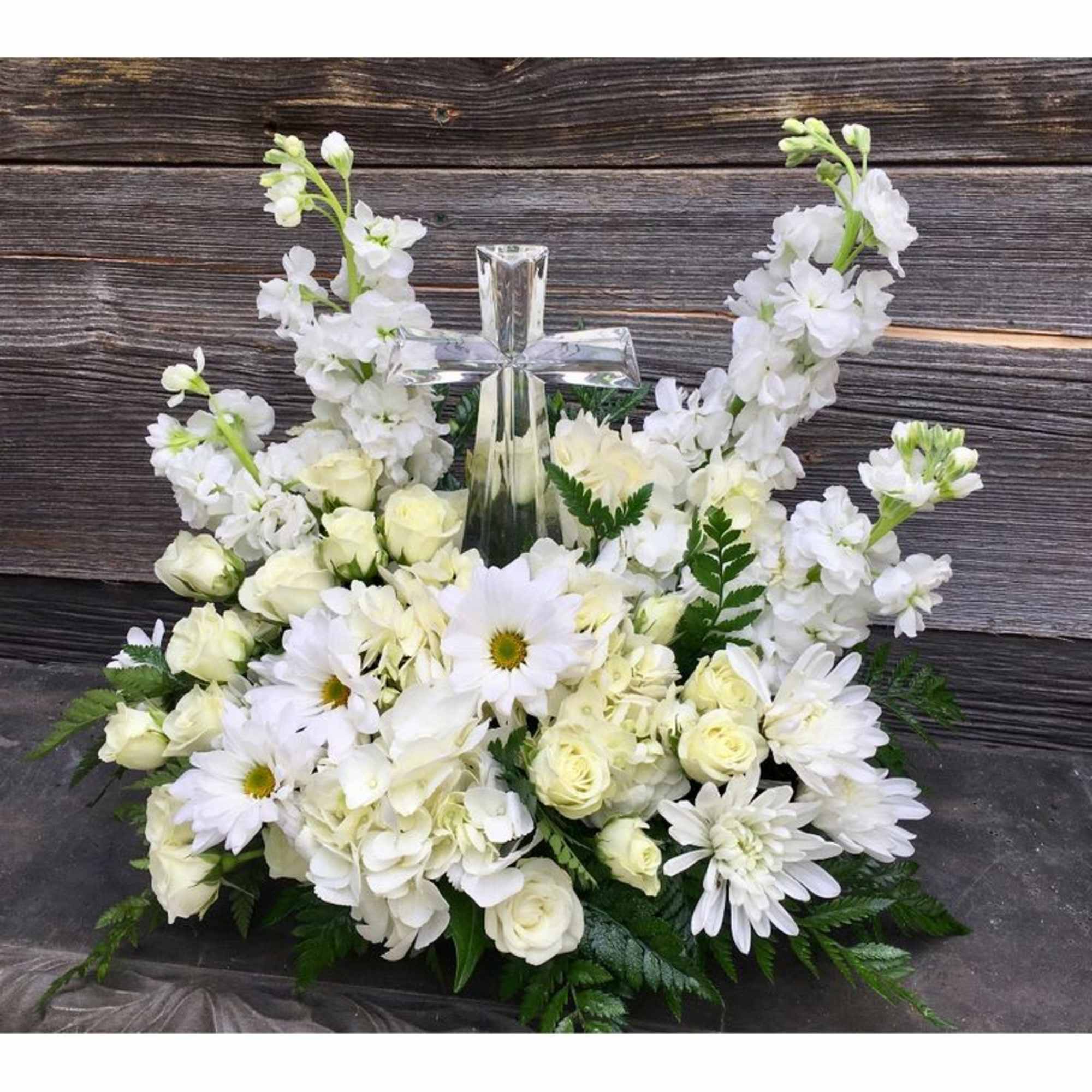An eloquent arrangement featuring at its' center, a beautiful glass crystal cross. An eloquent arrangement featuring at its' center, a beautiful glass crystal cross.