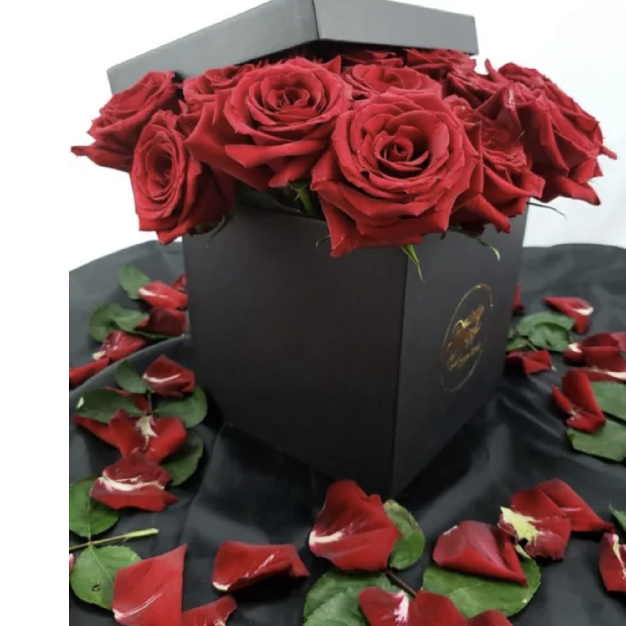12 (standard) or 24 (deluxe) Premium Roses placed in a decorative waterproof
