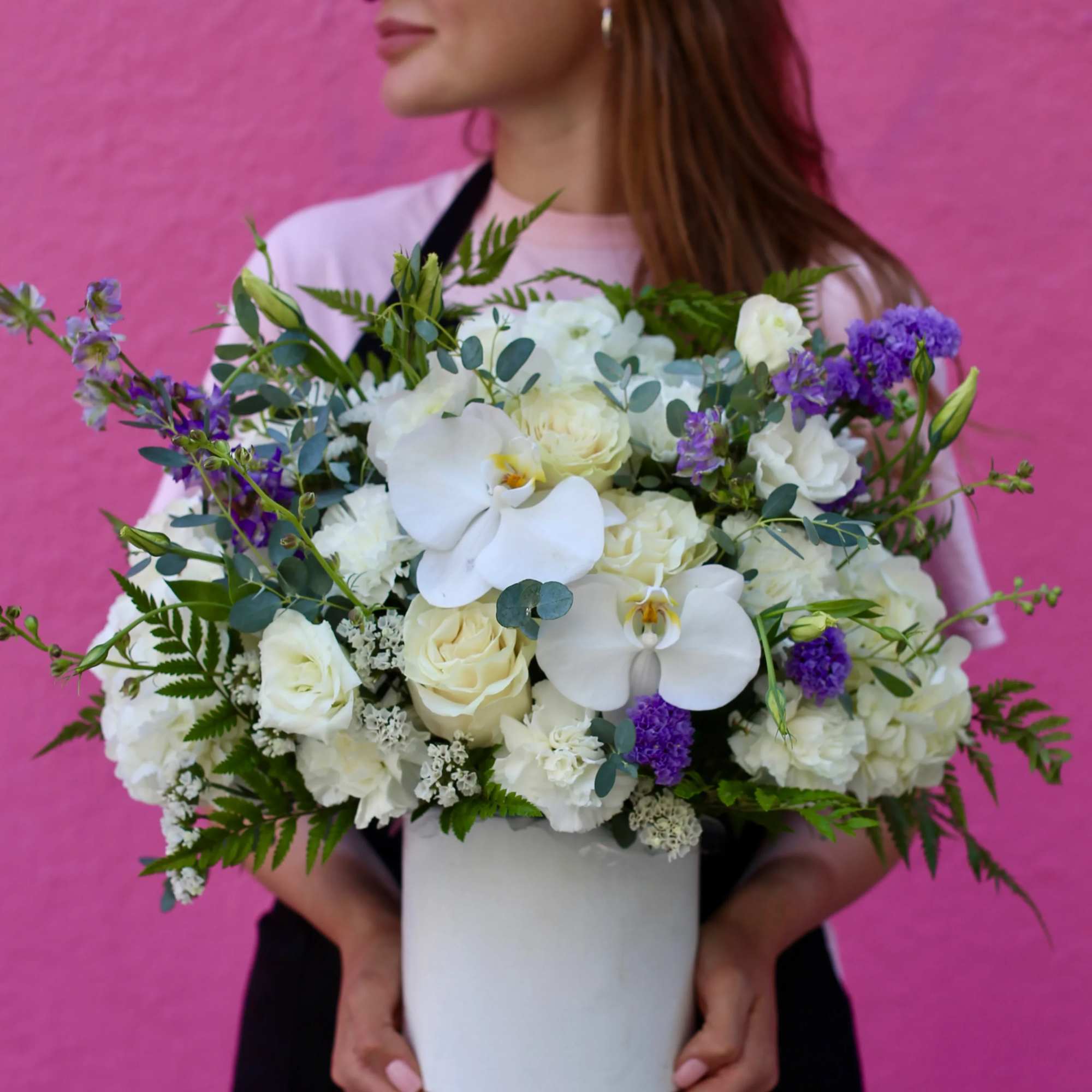 Lucie is a white floral composition made of orchids, roses, carnations with