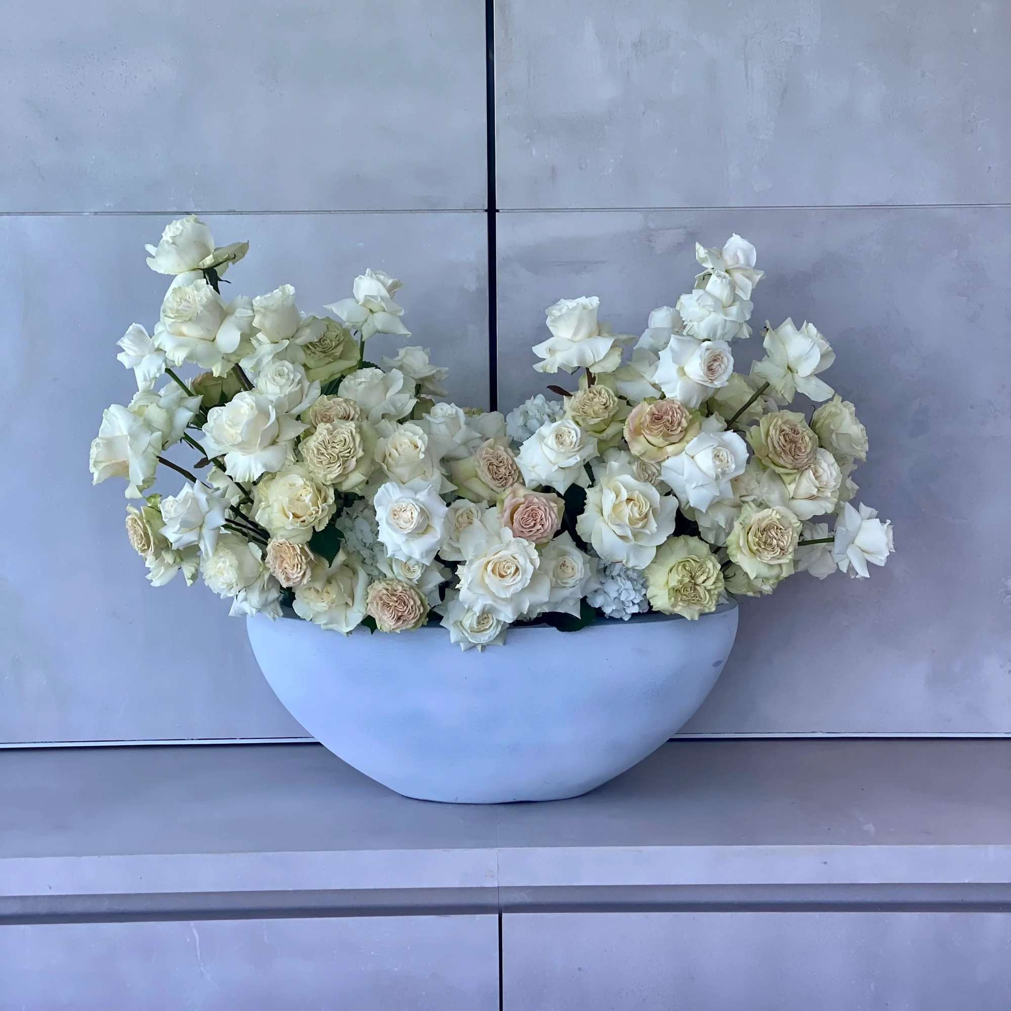 White and beige roses elegantly arranged in a vase, a serene and