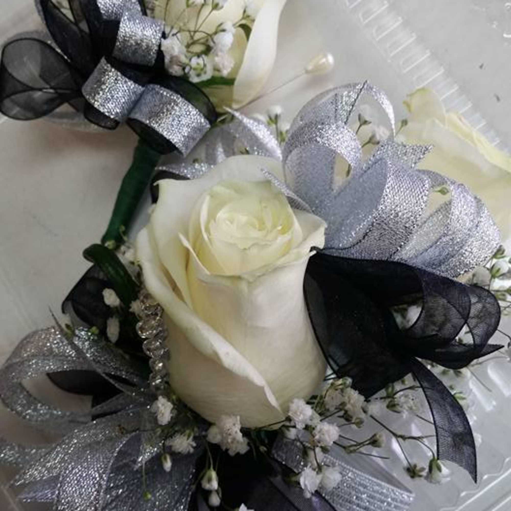 2 rose corsage
1 rose boutonniere

Color of your choice, specify in special instructions