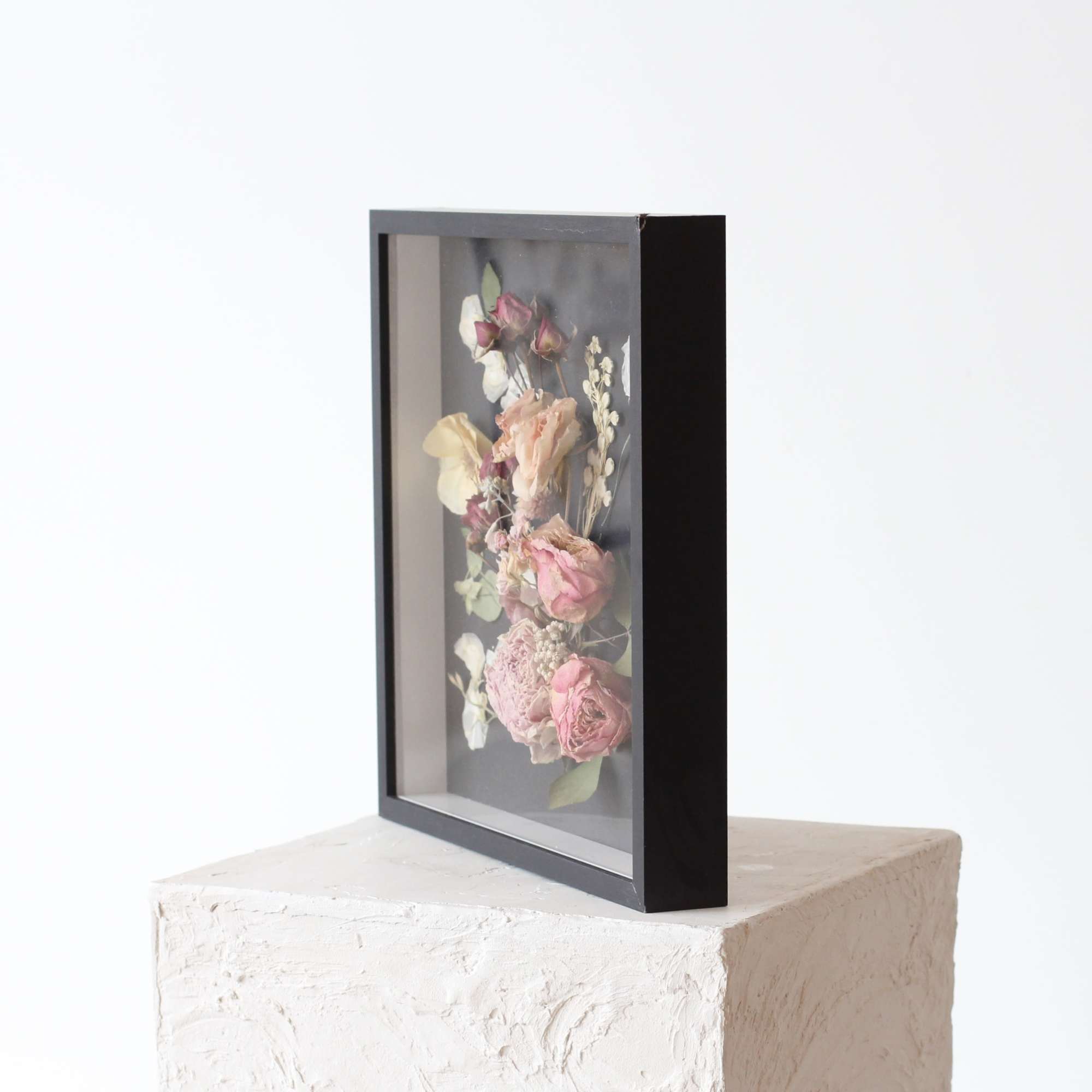 This elegant shadowbox features a stunning arrangement of delicate amethyst-colored dried flowers