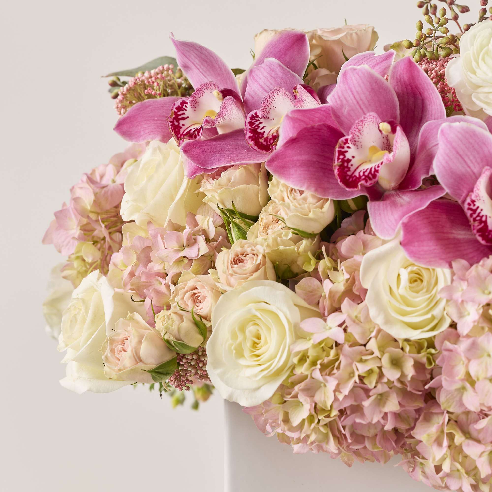 A white and pink floral arrangement can be described as a harmonious