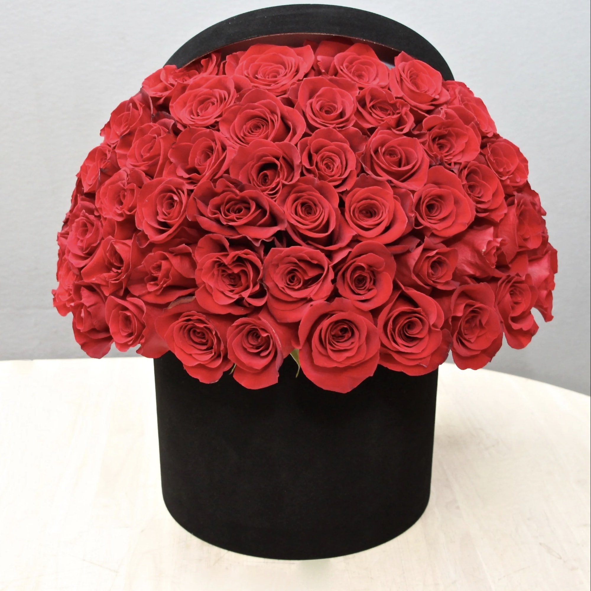 50 Premium Ecuadorian red roses perfectly arranged in a lux black velvet