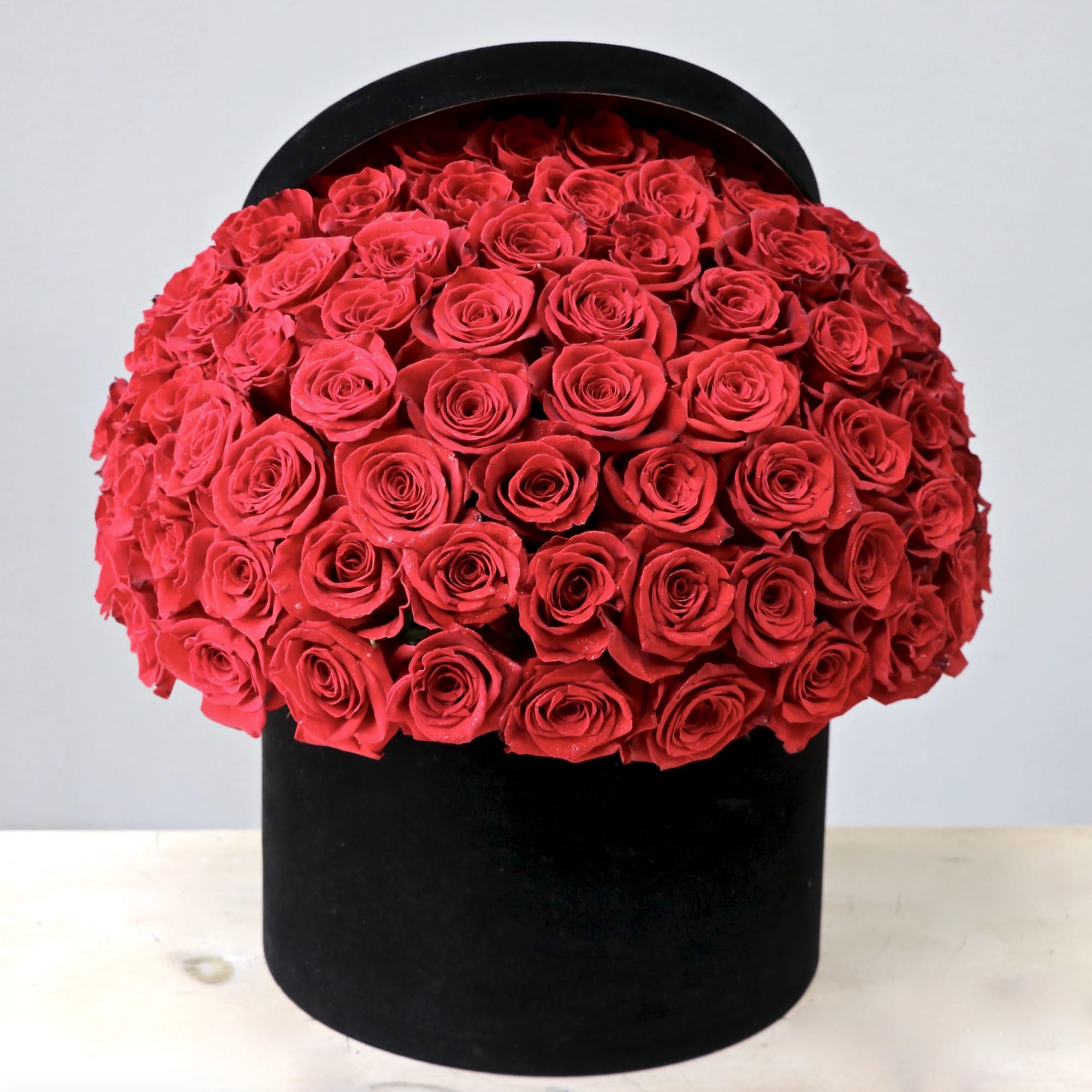 50 Premium Ecuadorian red roses perfectly arranged in a lux black velvet