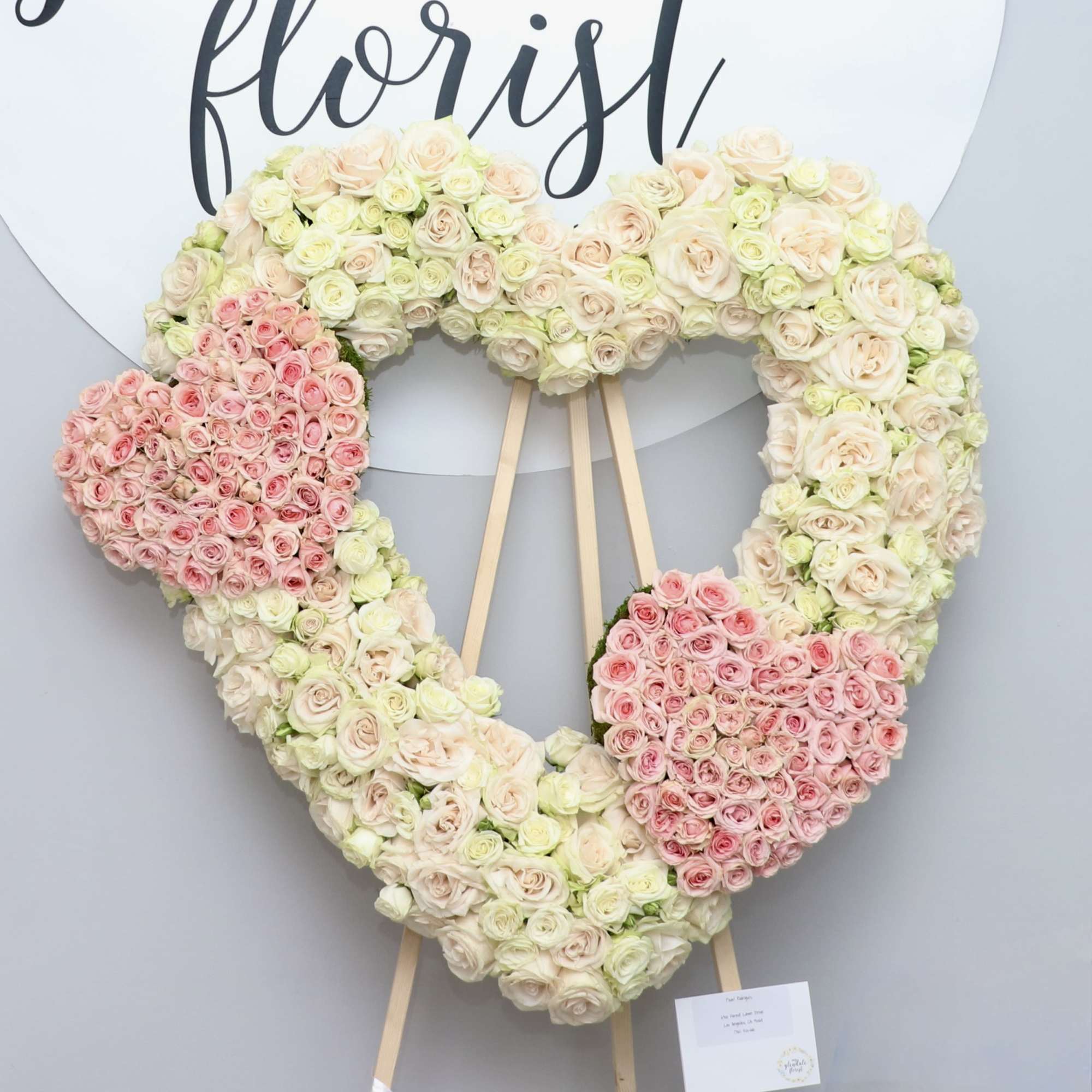 Three hearts in one, all containing red roses. The two smaller hearts