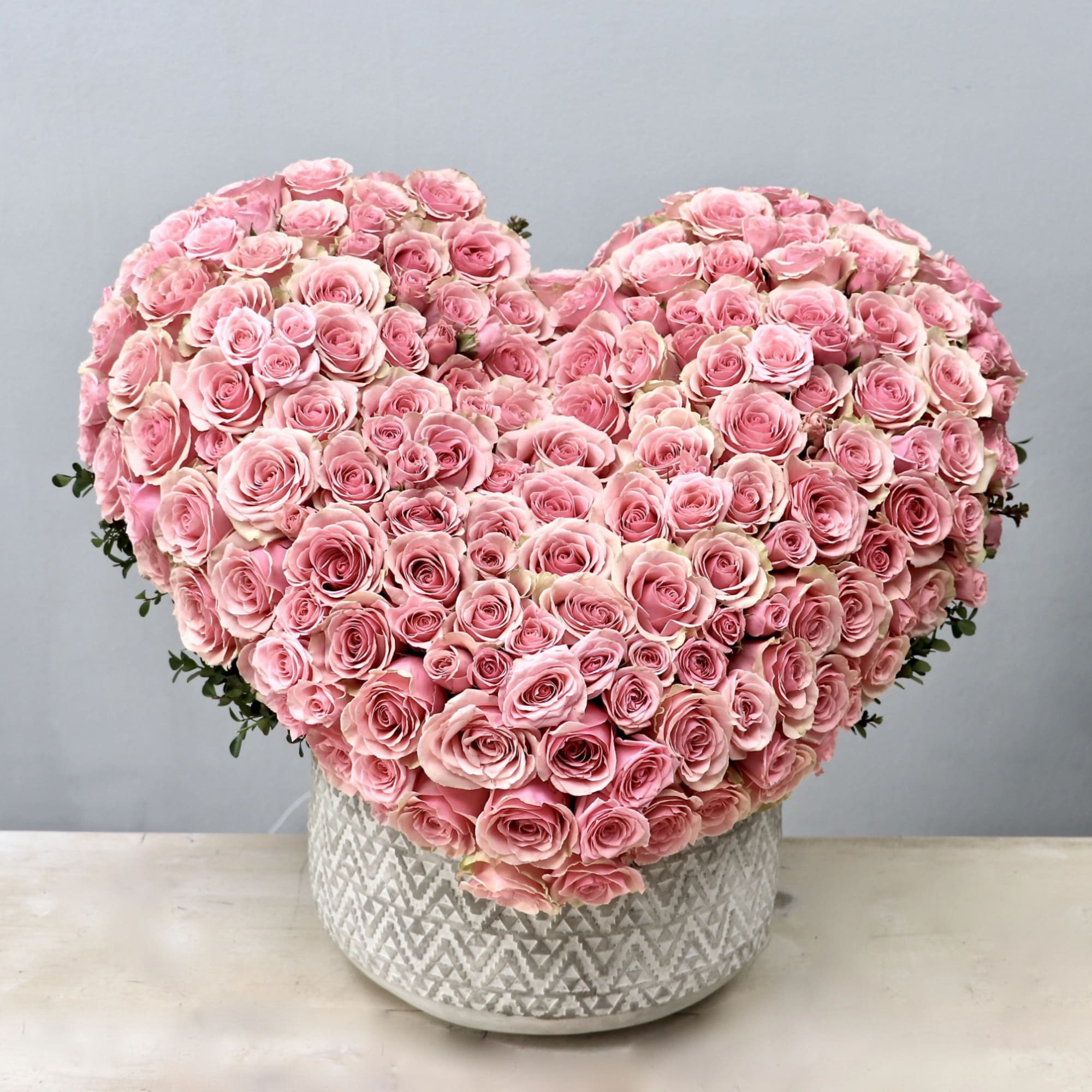 This hand crafted heart arrangement consists of 100 premium red roses. 
Make