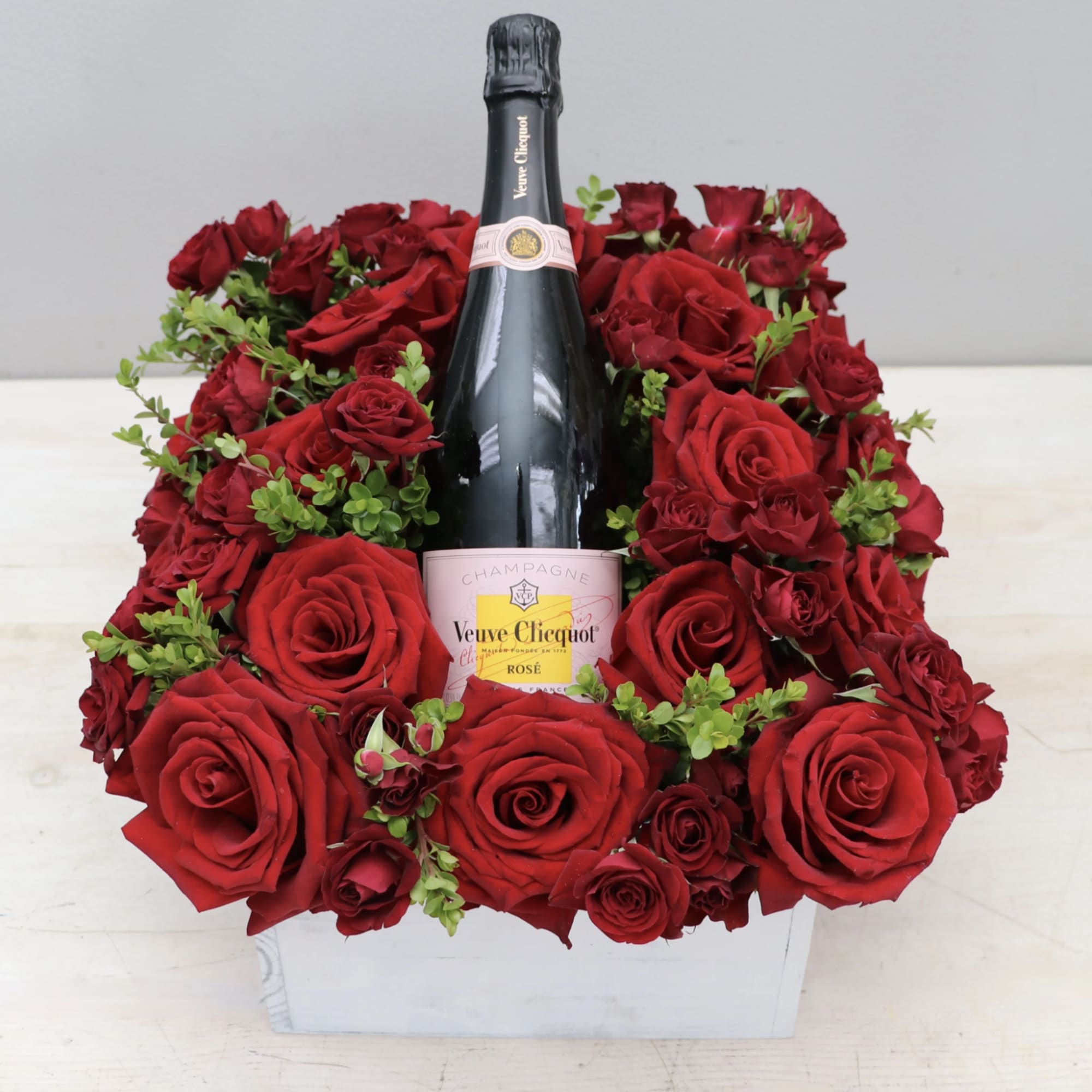 Feature your favorite bottle of bubbly surrounded lush red roses. Perfect for