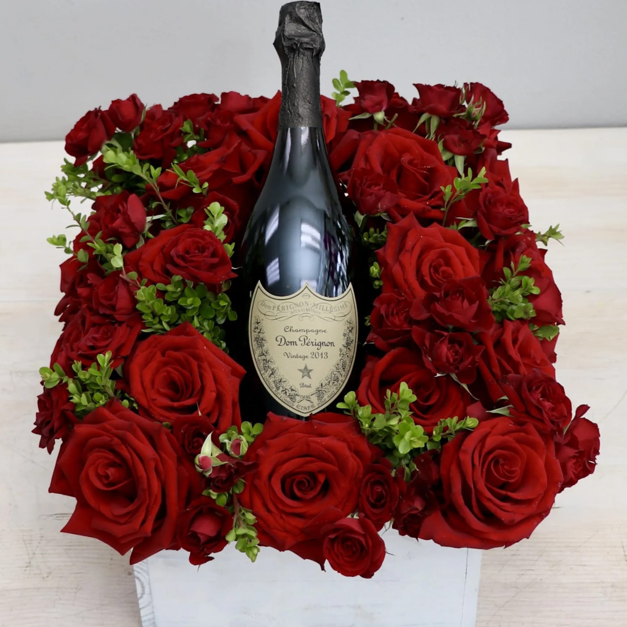 Feature your favorite bottle of bubbly surrounded lush red roses. Perfect for