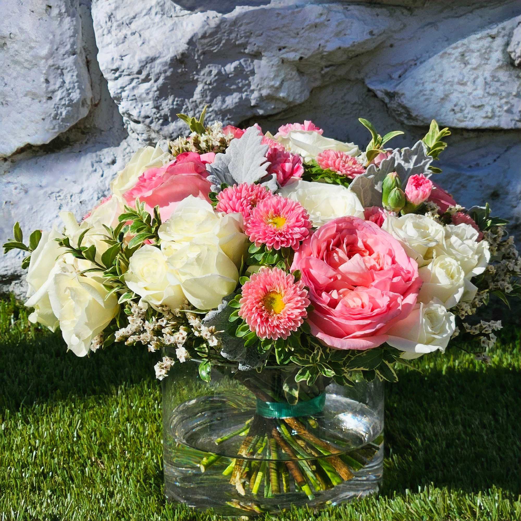 A symphony of pink and white roses gracefully arranged in a sleek