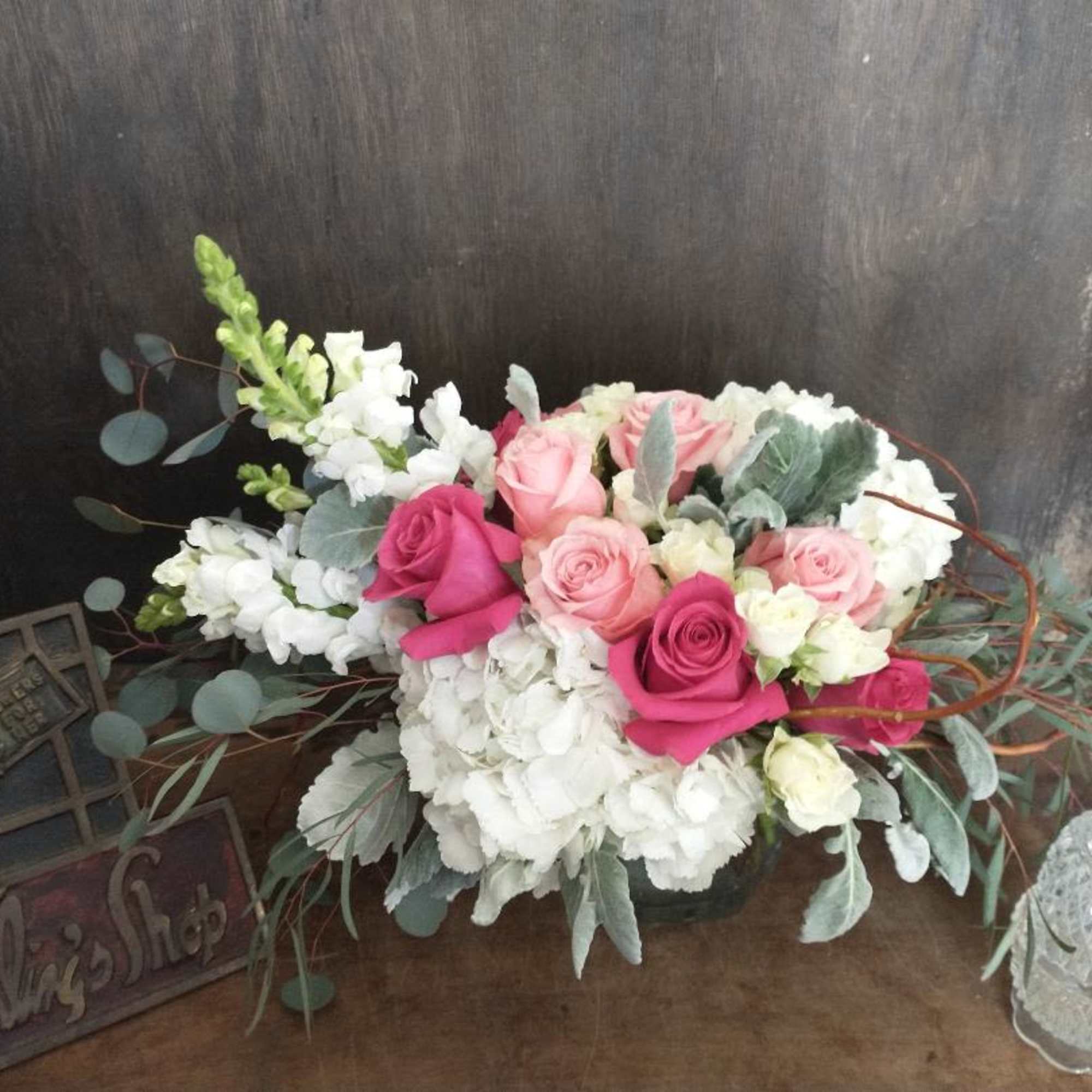 A nice assortment of roses and spray roses with hydrangeas and snaps