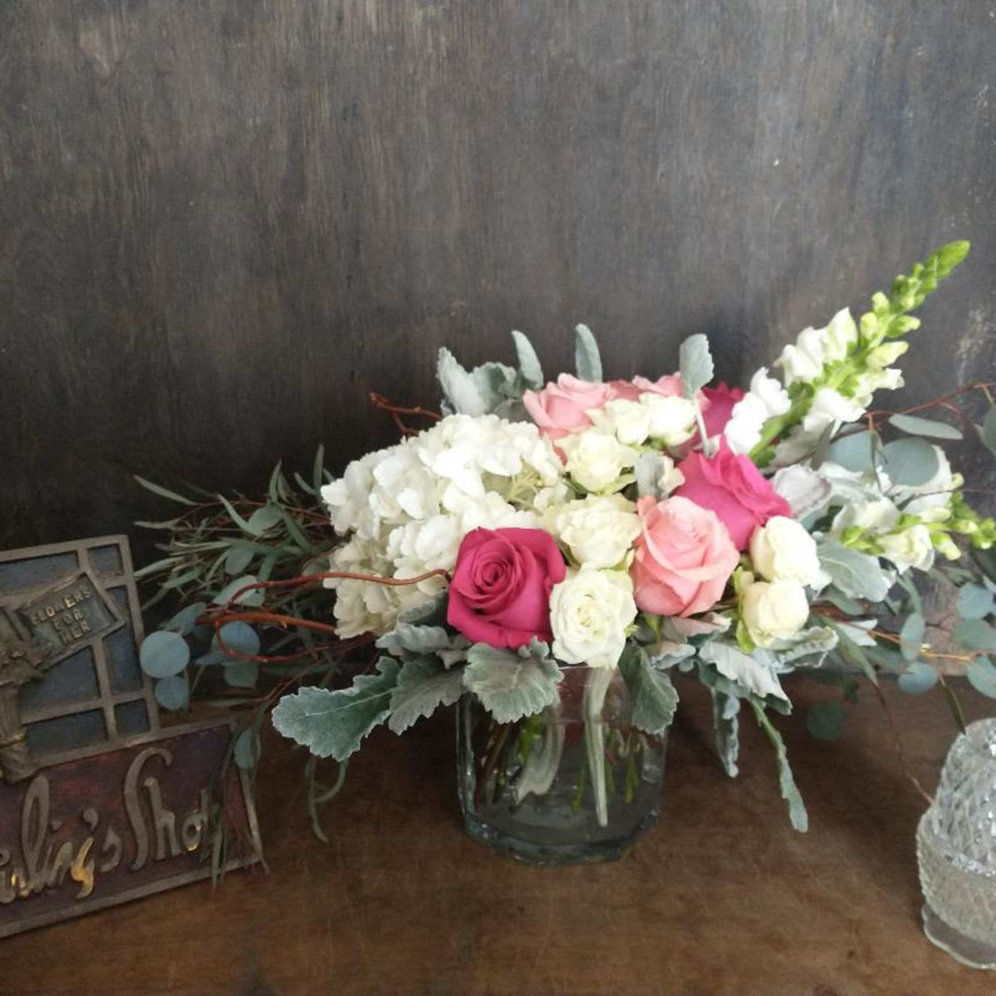 A nice assortment of roses and spray roses with hydrangeas and snaps