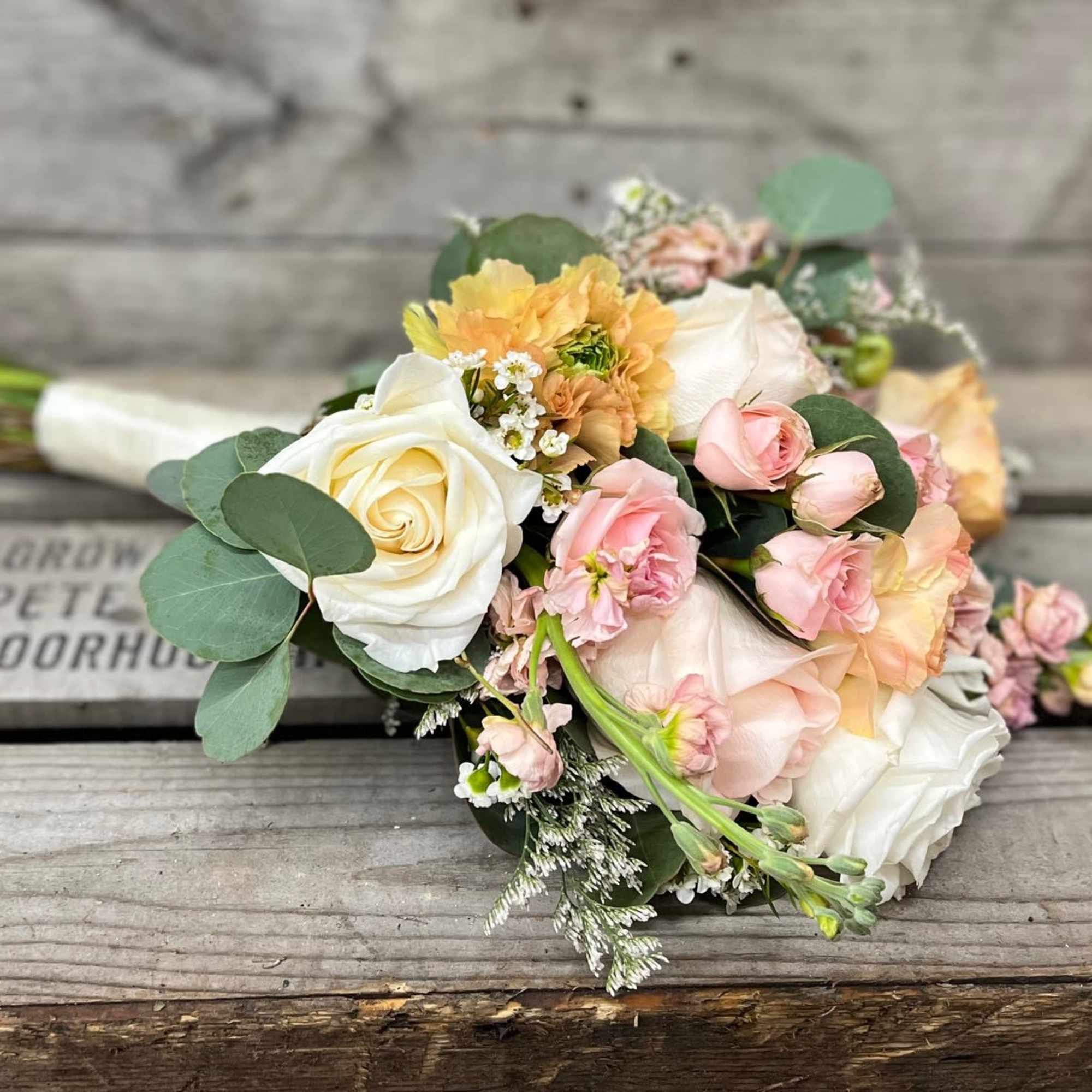 Mix of white, pink &amp; peach flowers arranged beautifully in small handheld