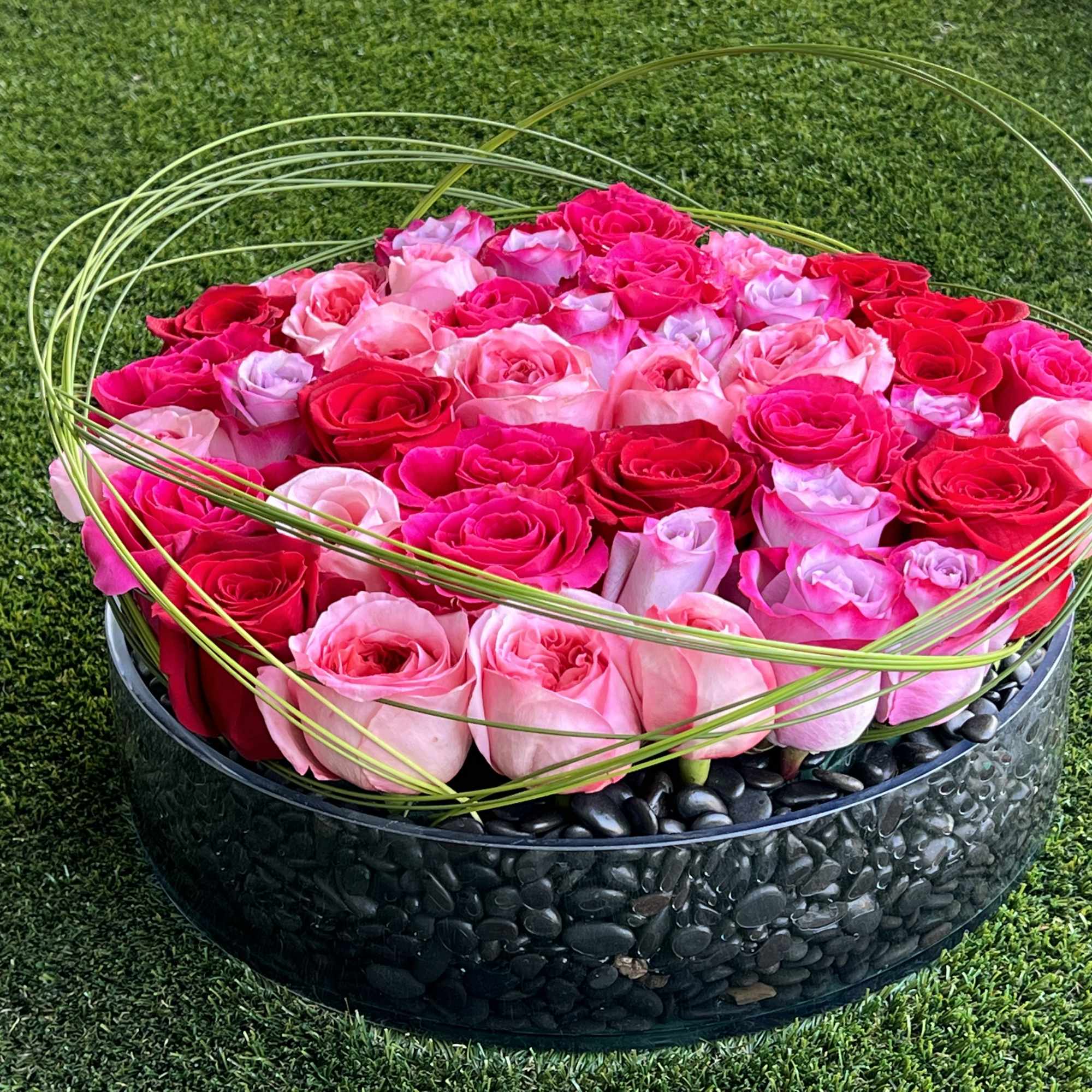 A romantic and modern bed of pink and red roses, adorned with
