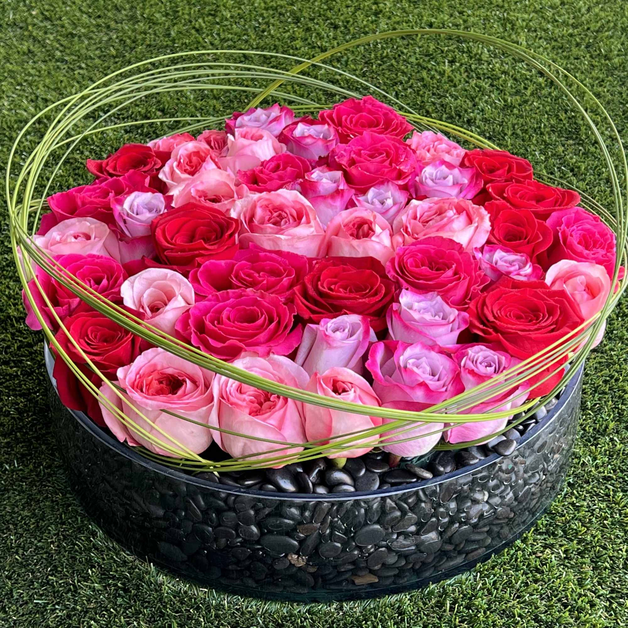 A romantic and modern bed of pink and red roses, adorned with