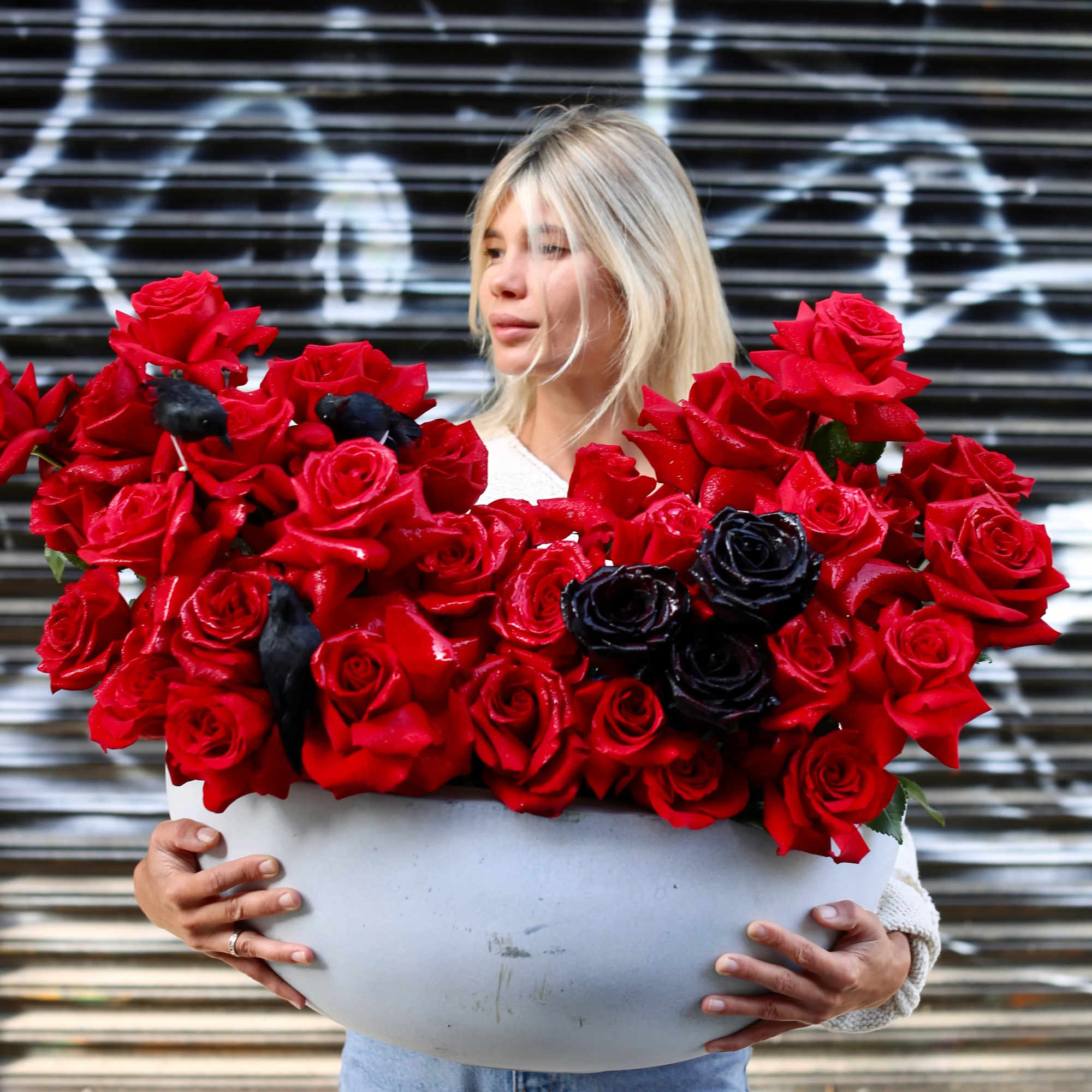 Amore is a luxury flower arrangement featuring rich red and black roses