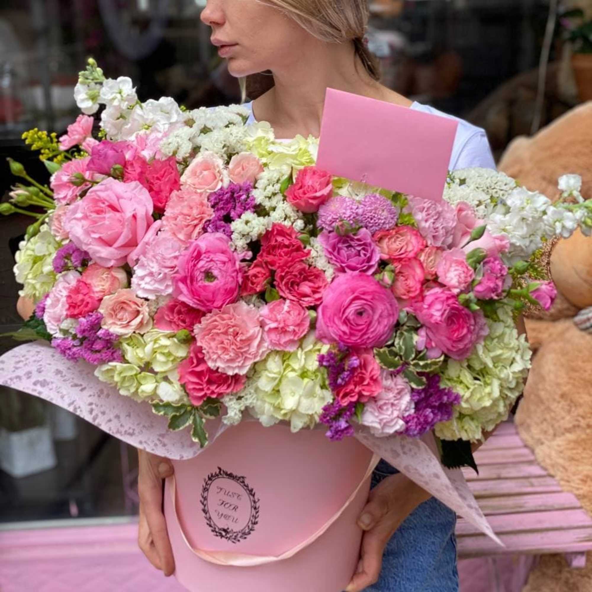 Arrangement of white hydrangea, ranunculus,carnations and roses.